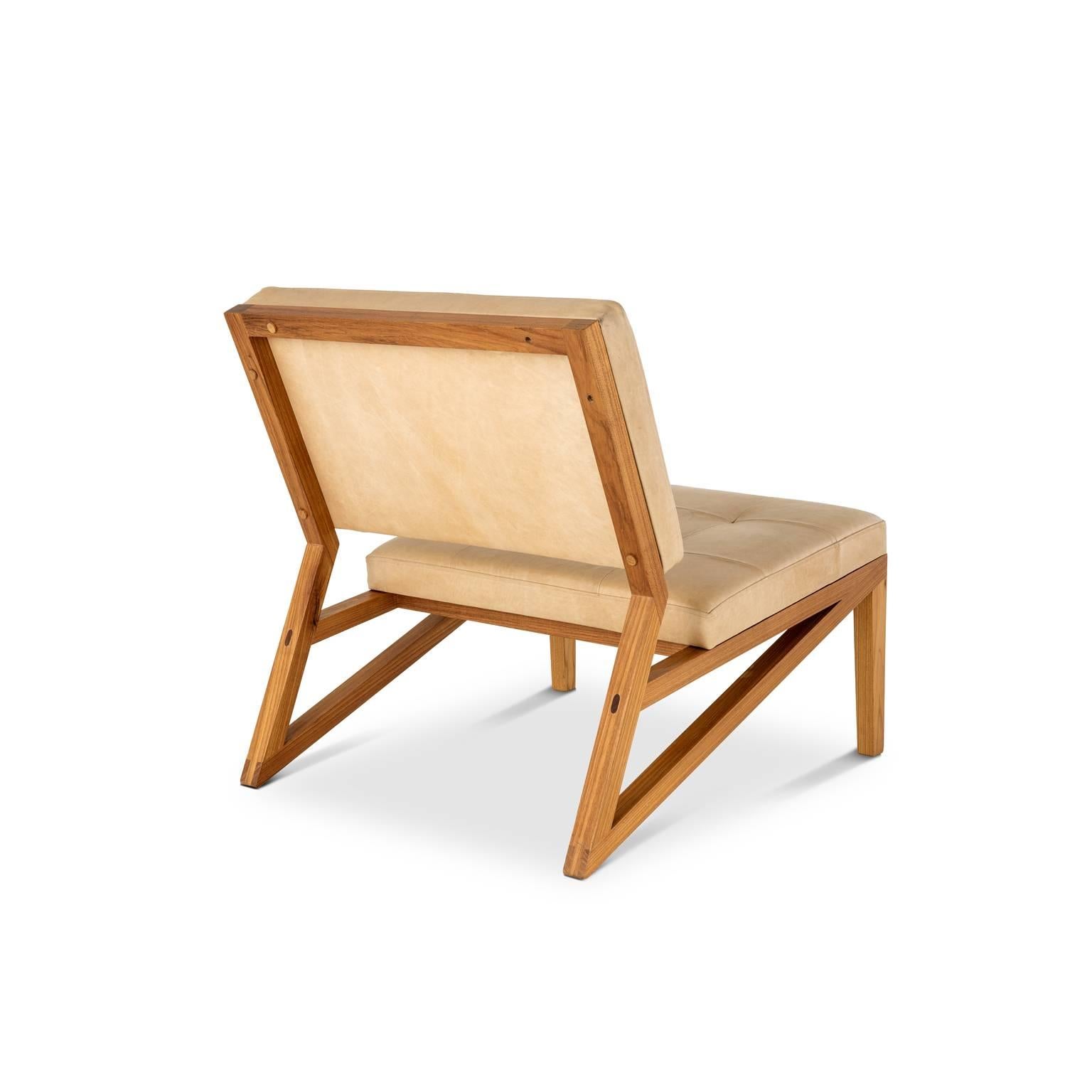 The lounge chair Cim is made in Brazilian solid wood freijó with traditional handcraft joint techniques. The seat is in plywood, straps, foam and leather. Finishing in Italian acrylic matte varnish that shows the beauty of wood.