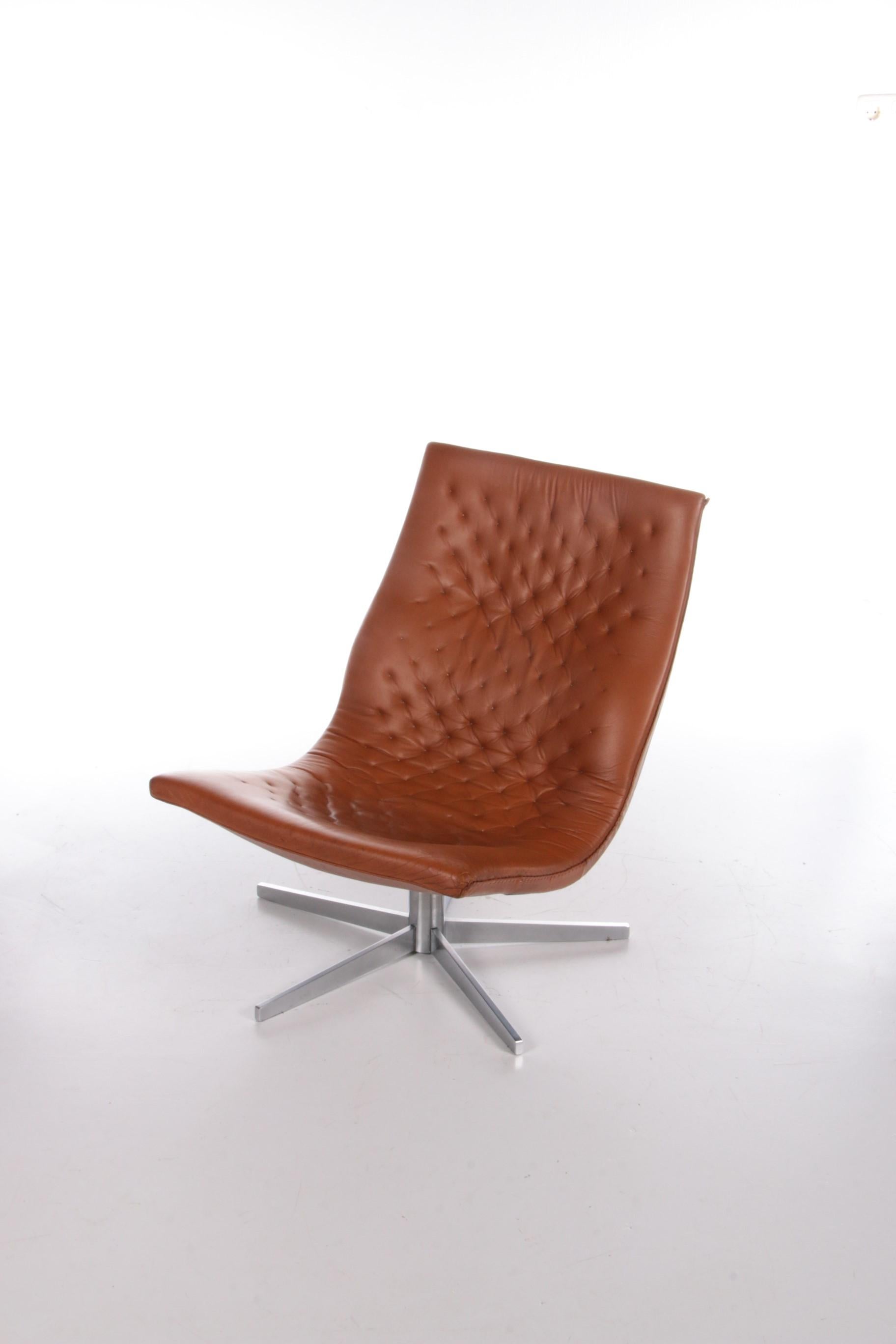 Beautiful Cognac color leather relax armchair made by De Sede Switzerland.

The chair has a metal bottom with a nice foot.

This chair is completely handmade and the edge is completely closed by hand, this is really a top armchair.

The patina
