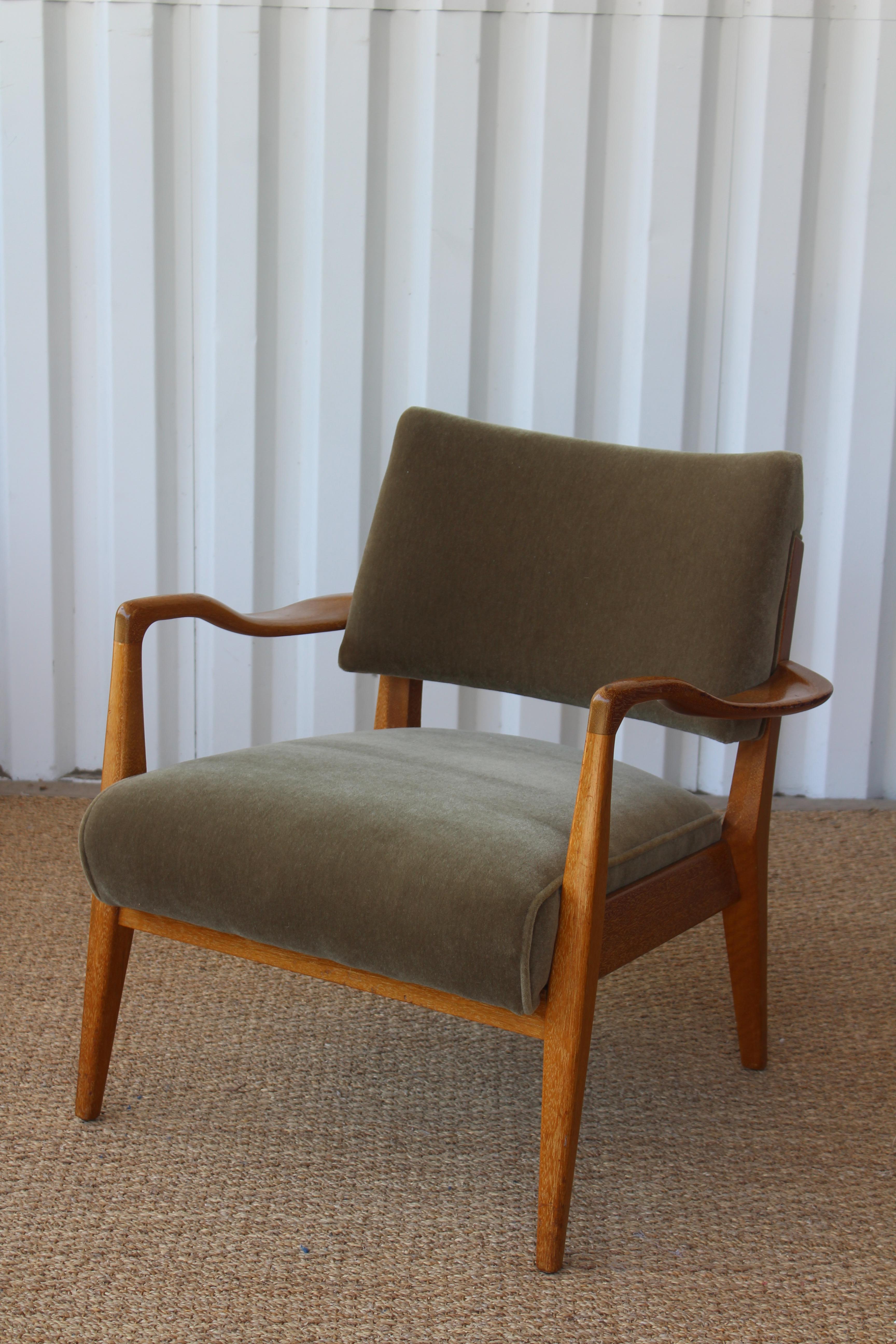 Mid-Century Modern lounge chair designed by Paul Laszlo for Brown Saltman, U.S.A, 1950s. The frame is solid mahogany in an almost cerused like finish. Beautiful sculpted arms. Newly upholstered in an olive green Italian wool mohair. Frame shows
