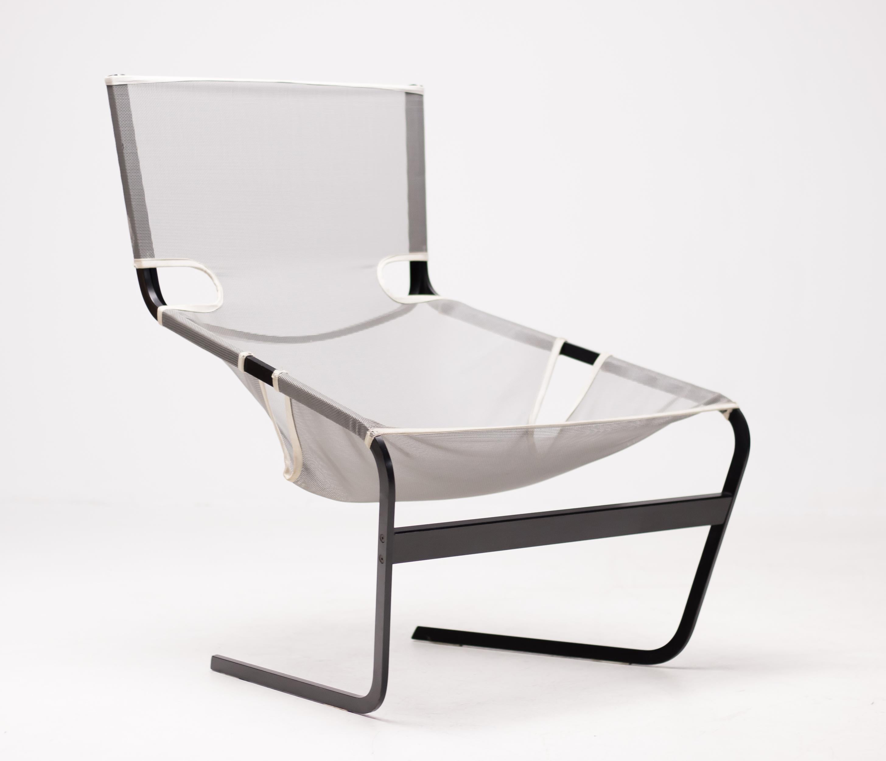 Unusual implementation of this well-known Pierre Paulin design. 
Black metal frame and mesh sling seat.
Marked and labeled. Very comfortable chair!