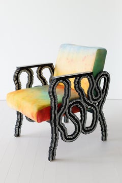 Lounge chair in wood with hand-dyed upholstered seat
