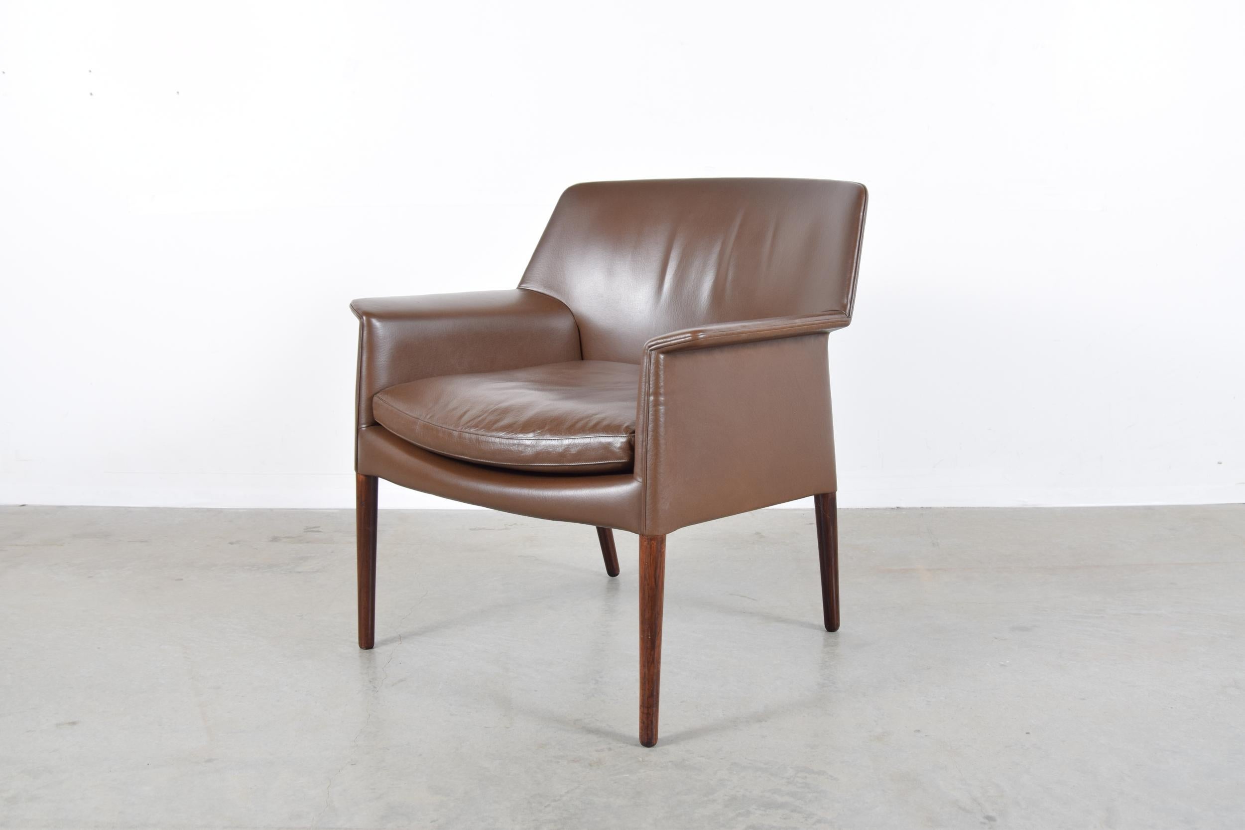Lounge chair in leather and rosewood, designed by Ejner Larsen and Aksel Bender Madsen, and produced in Denmark by Ludvig Pontoppidan, circa 1958.