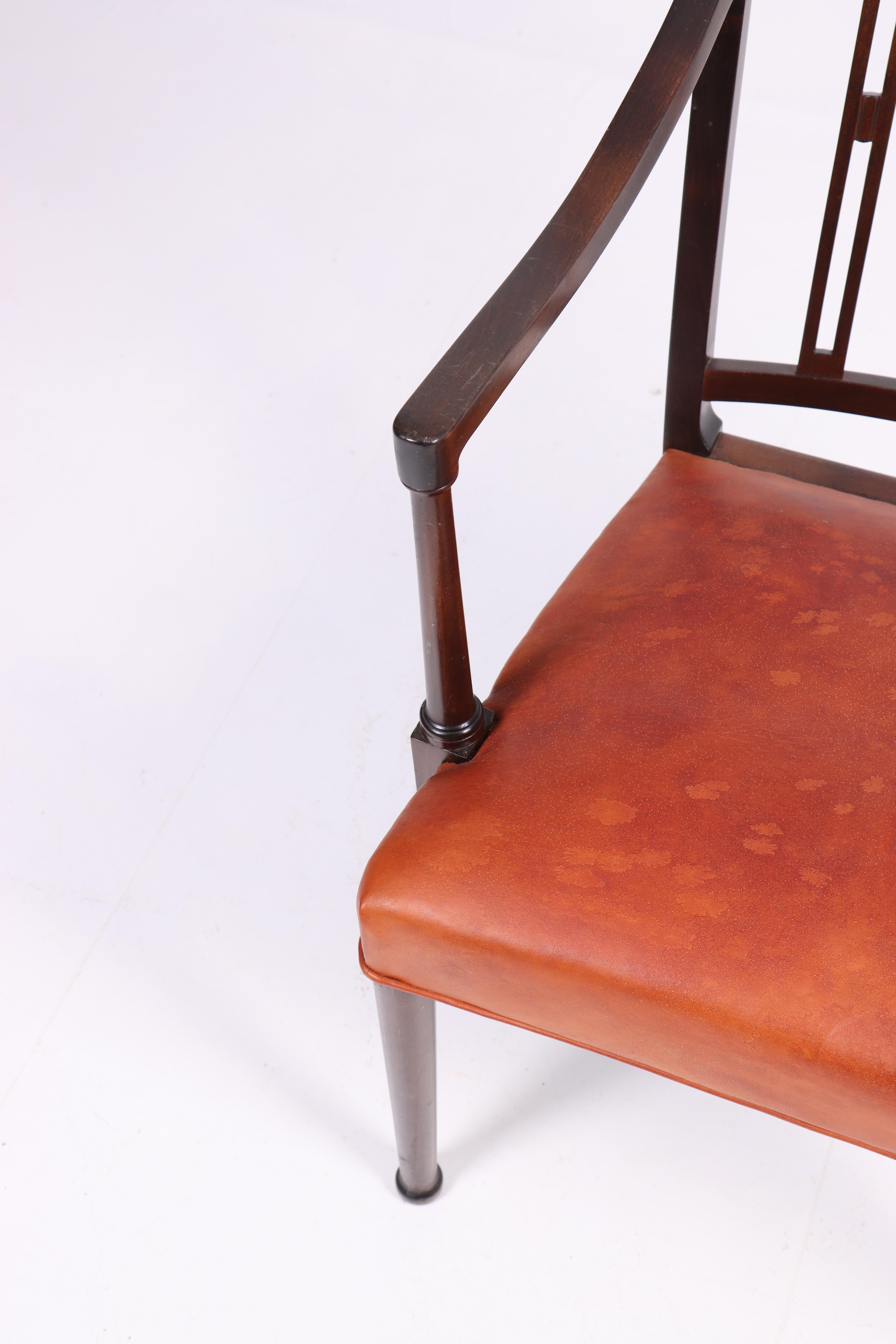 Arm chair in patinated leather designed by Ole Wanschar M.A.A. for A.J. Iversen Cabinetmakers in 1950s. Made in Denmark. Great condition.