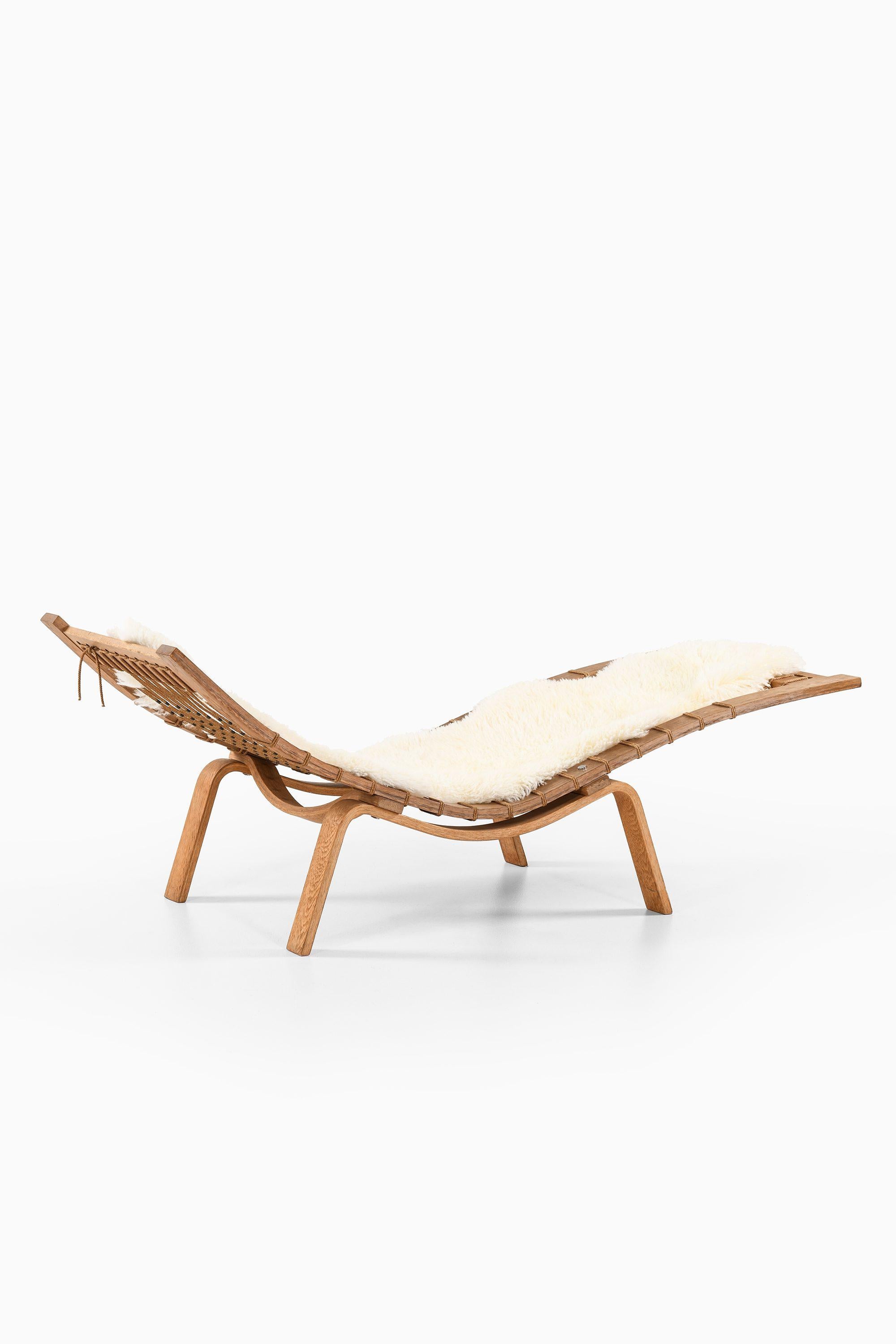 Lounge Chair in Oak and Sheepskin by Hans Wegner, circa 1960s

Additional Information:
Material: Oak, flagline, sheepskin
Style: midcentury, Scandinavia
Very Rare Lounge Chair Model GE-2
Produced by GETAMA in Denmark
Dimensions (W x D x H):