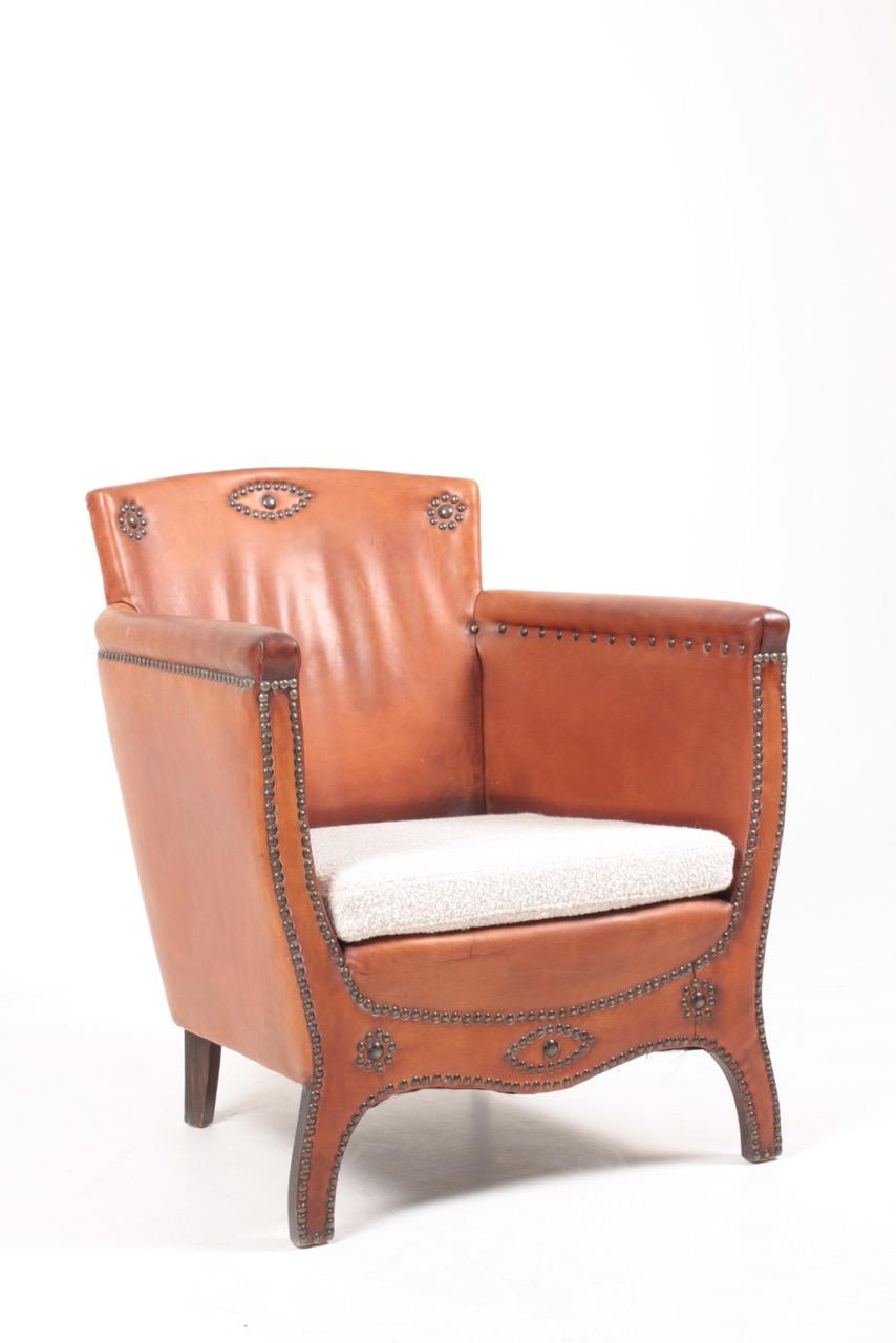 Lounge chair in leather and boucle. Designed by Otto Schulz and made by Boet AB. Great condition.