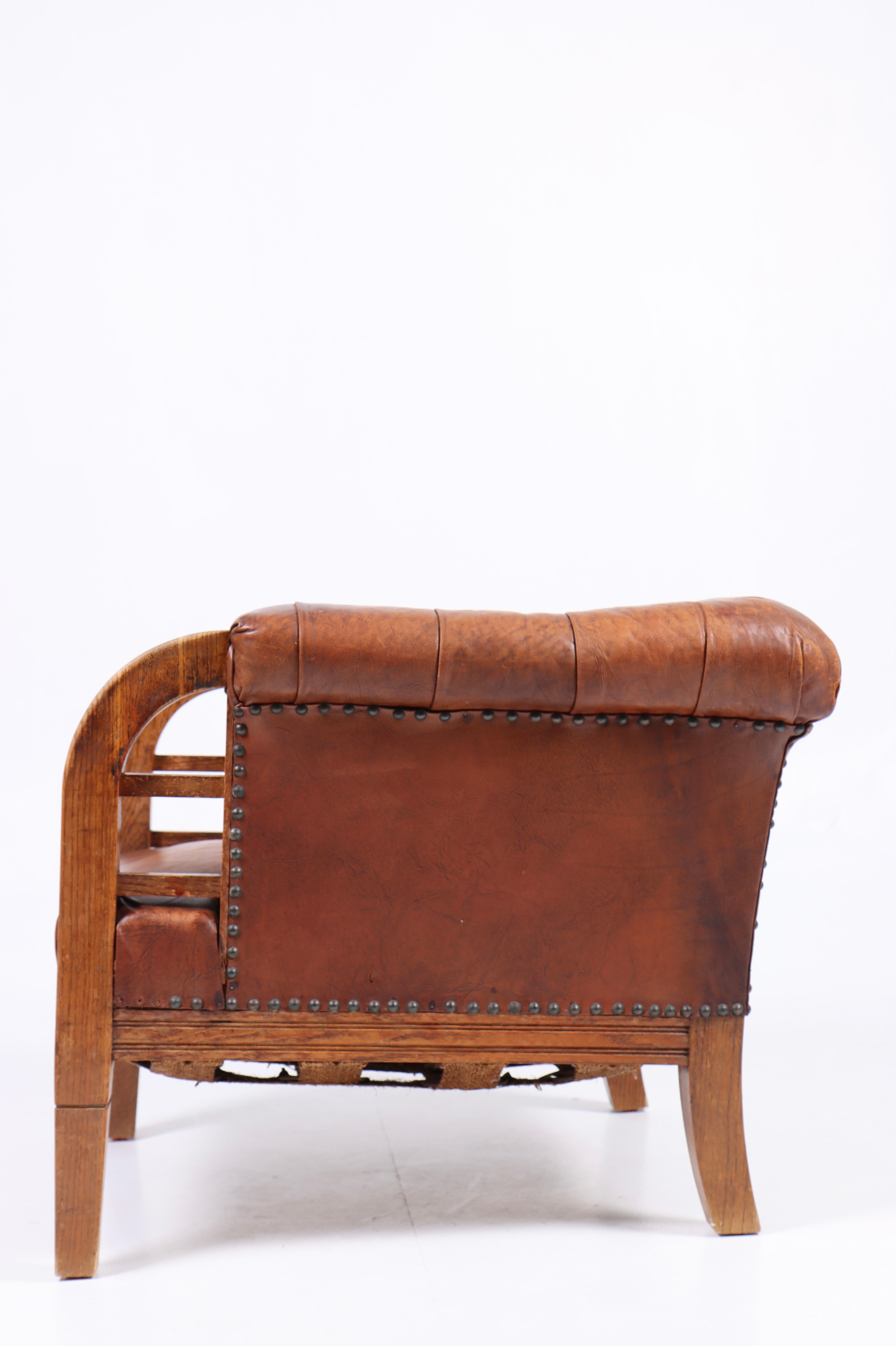 Mid-20th Century Lounge Chair in Patinated Leather, Made in Denmark, 1940s For Sale