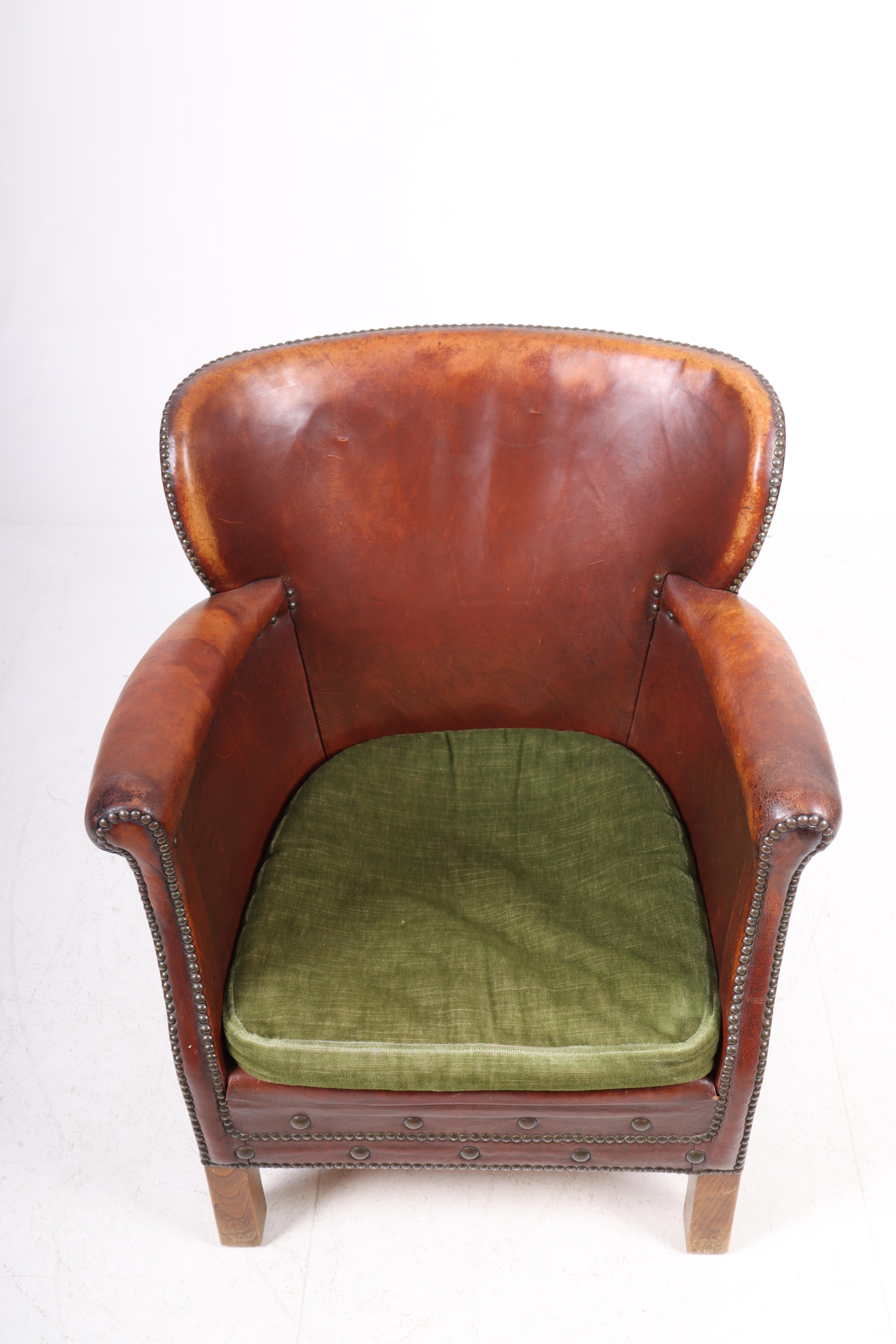 Lounge chair in leather and fabric. Designed and made in Sweden. Original condition.