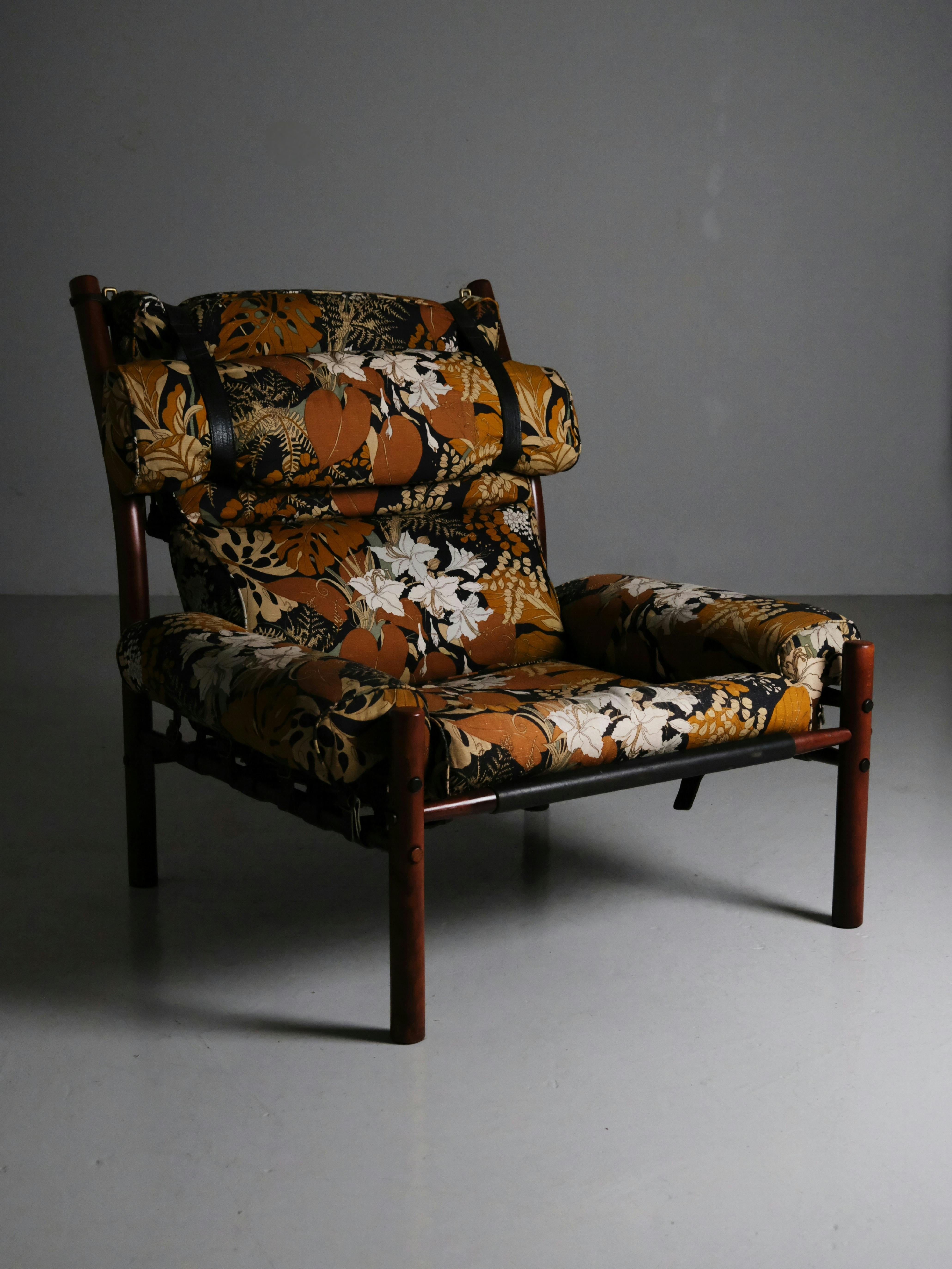 Great lounge chair by renowned Swedish designer Arne Norell for his own company during the 1970s. 

Model 'Inca' is big and comfortable. Body of beech with couchins of original flower fabric in good condition. Leather details holds it all together.