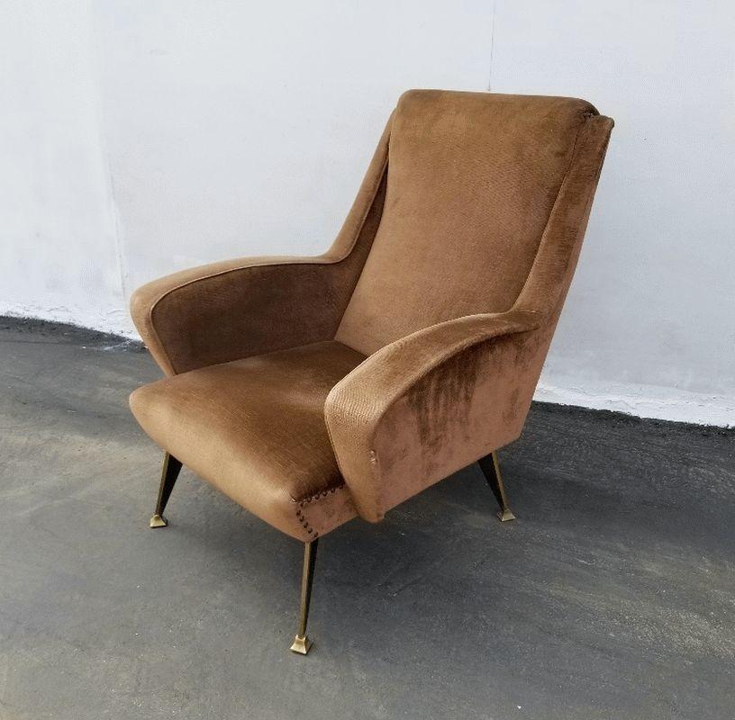 Original upholstery in coffee late color, brass legs that are special design and made for this chair. Still very comfortable and presentable.