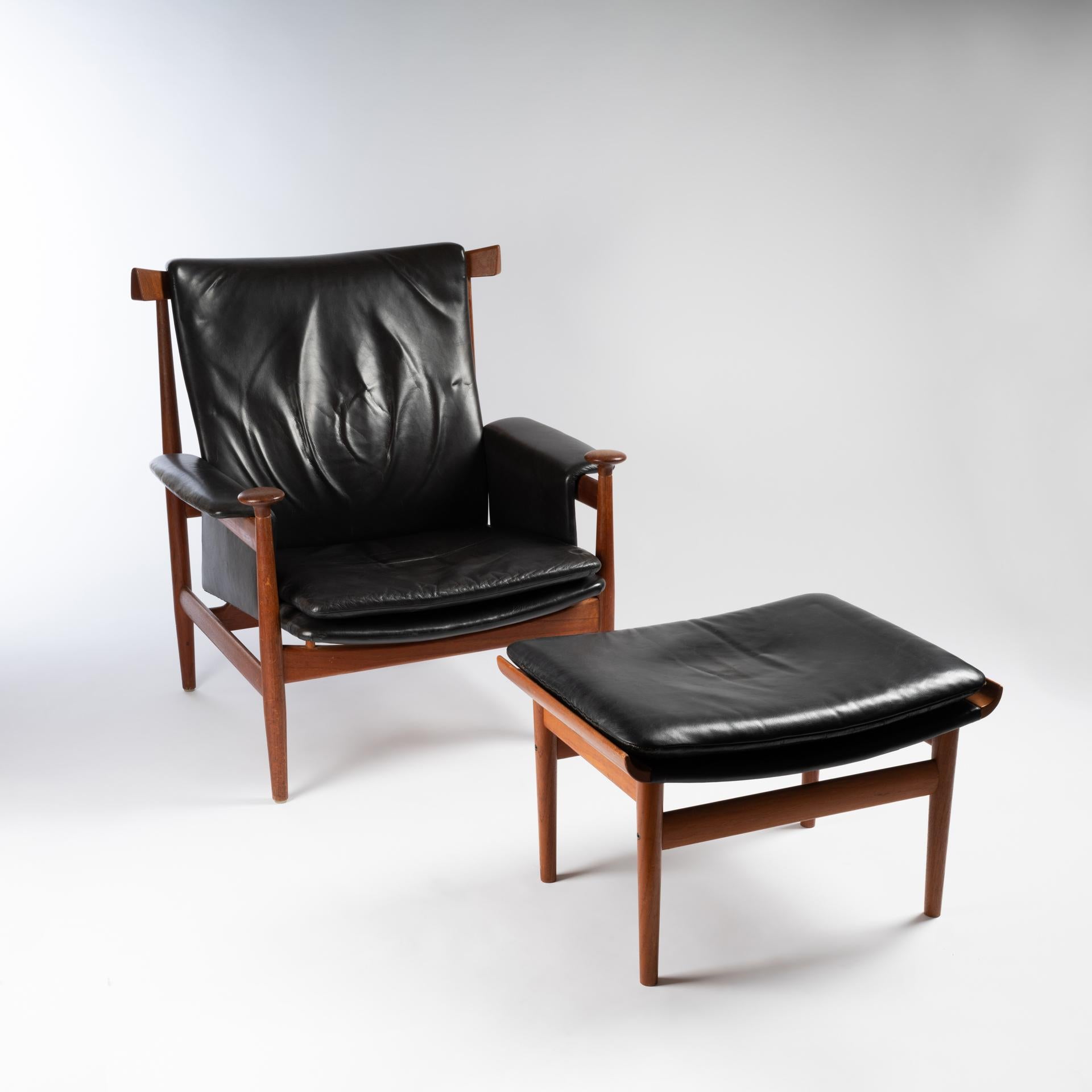 Superbly comfortable and strikingly designed, this model by master Finn Juhl was produced by France and Son in Denmark in 1962. With distinctive tassels on the front of the leather arms and an arched backrest, this chair draws on African and Asian
