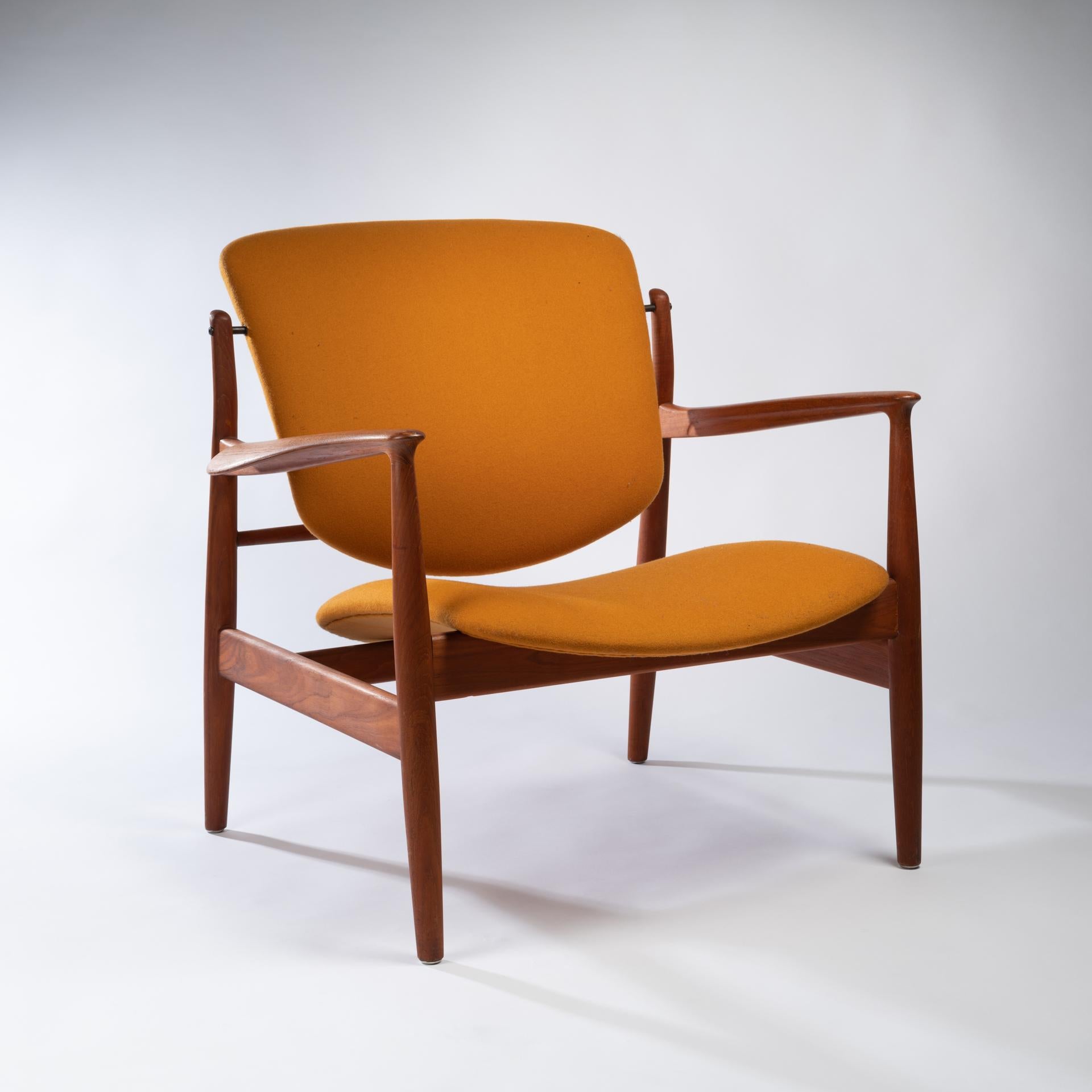 The Iconic FD-136 teak lounge chairs were designed by Finn Juhl for France and Sons in 1950. Special attention was given to the finely carved arms. The Lounge Chair is in very good condition, with an attractive patina on the sturdy frame. The