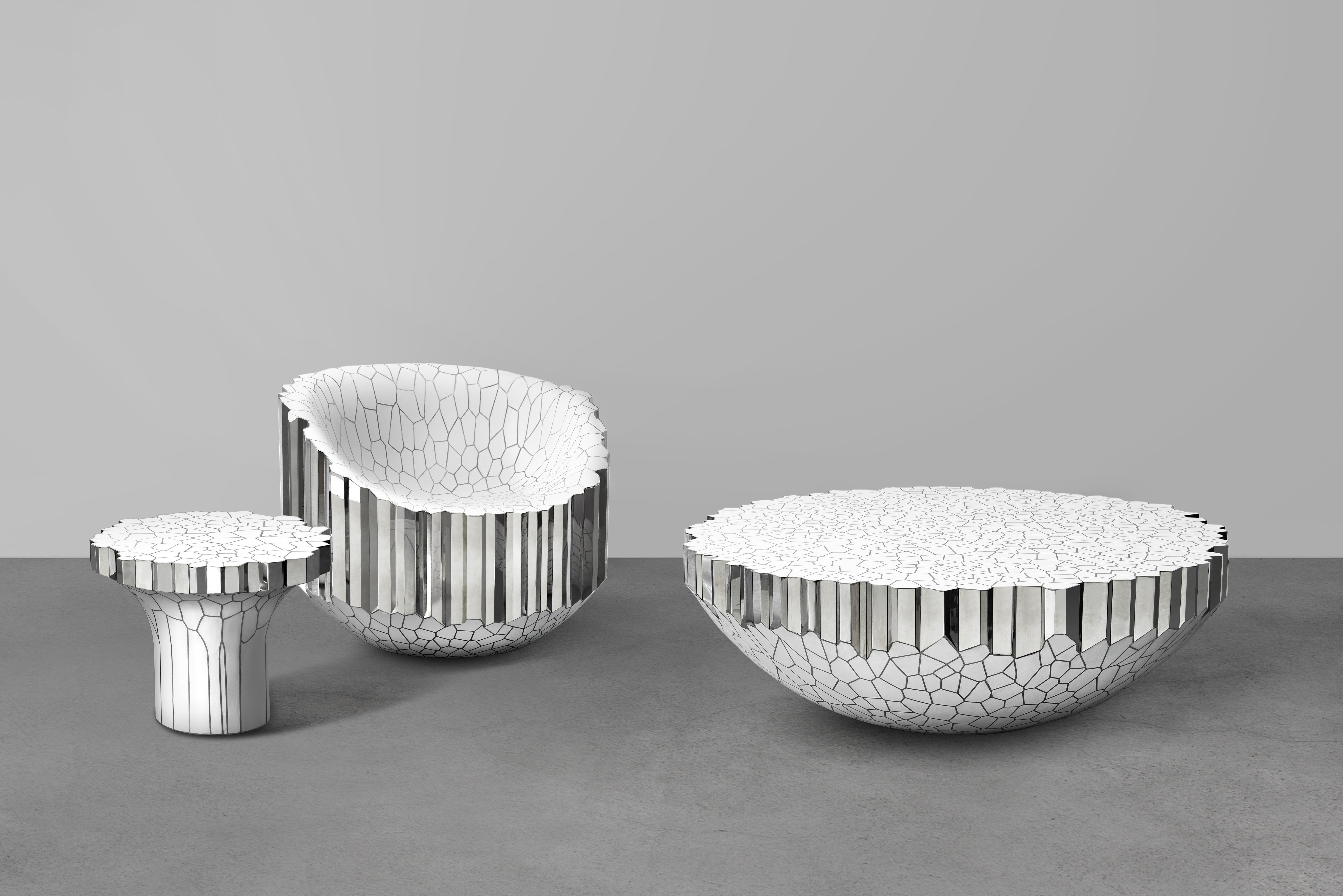 The collection consists of a chair, a side table, a writing desk, a round coffee table, a console and a lounge chair. All the work in the collection will be composed of polished stainless steel with white enamel surfaces. Each piece consists of a