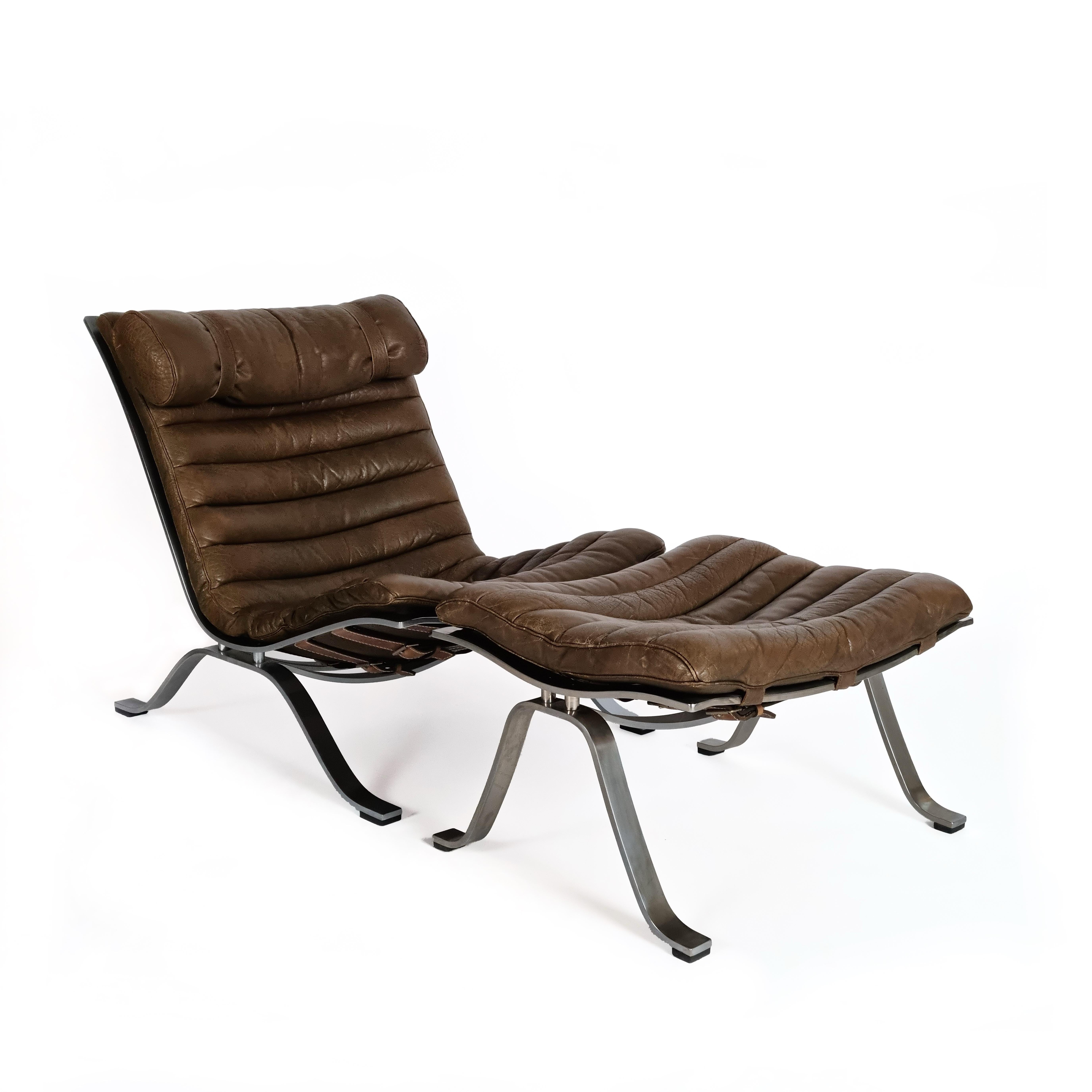 Ari lounge chair & ottoman with a chrome steel frame, designed by Swedish designer Arne Norell in 1960. This vintage lounge chair & ottoman are in aniline leather. This leather is naturally tanned and dyed, giving it a distinct sheen. The chair