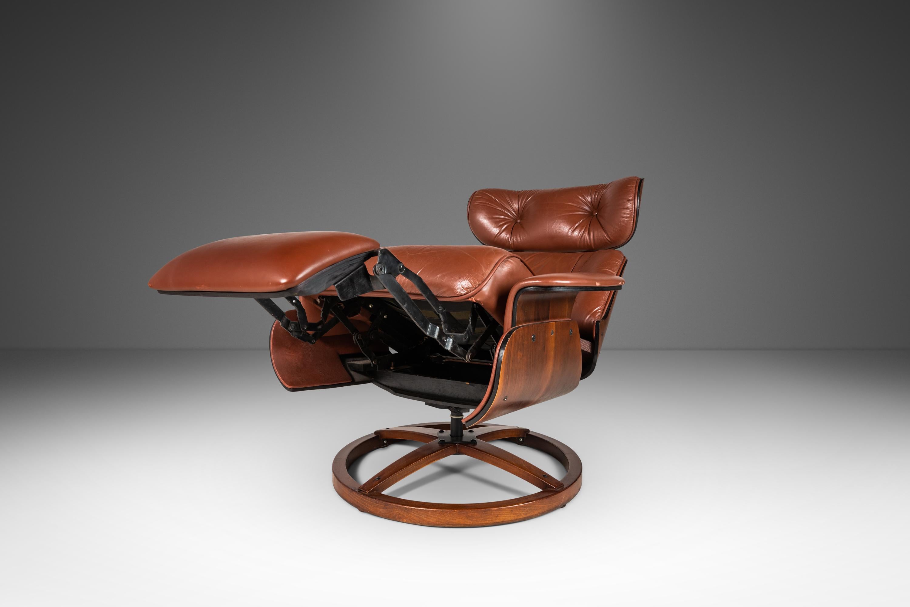 A rare 1960s design drawing influences from the Iconic Model 670 and Model 671 Eames Chair and Ottoman. This Lounge chair is found in the original brown Naugahyde upholstery which rests in it's sculpted walnut form. The chair is then set on a