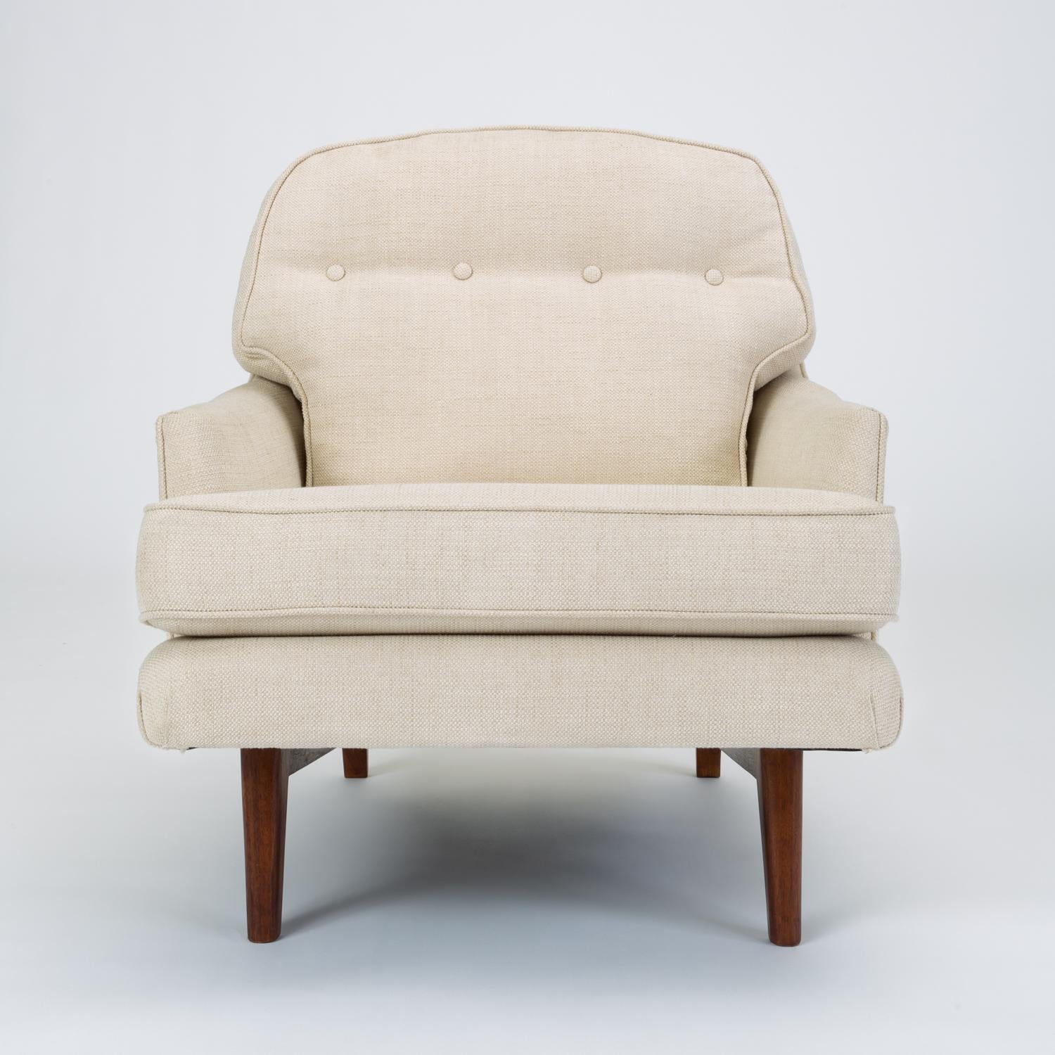 Designed by Edward Wormley’s successor at Dunbar, Roger Sprunger, the Model 484 lounge chair has a deep seat and notched armrests. The removable back and seat cushions are defined by welted seams and the back has a single row of tufting at shoulder