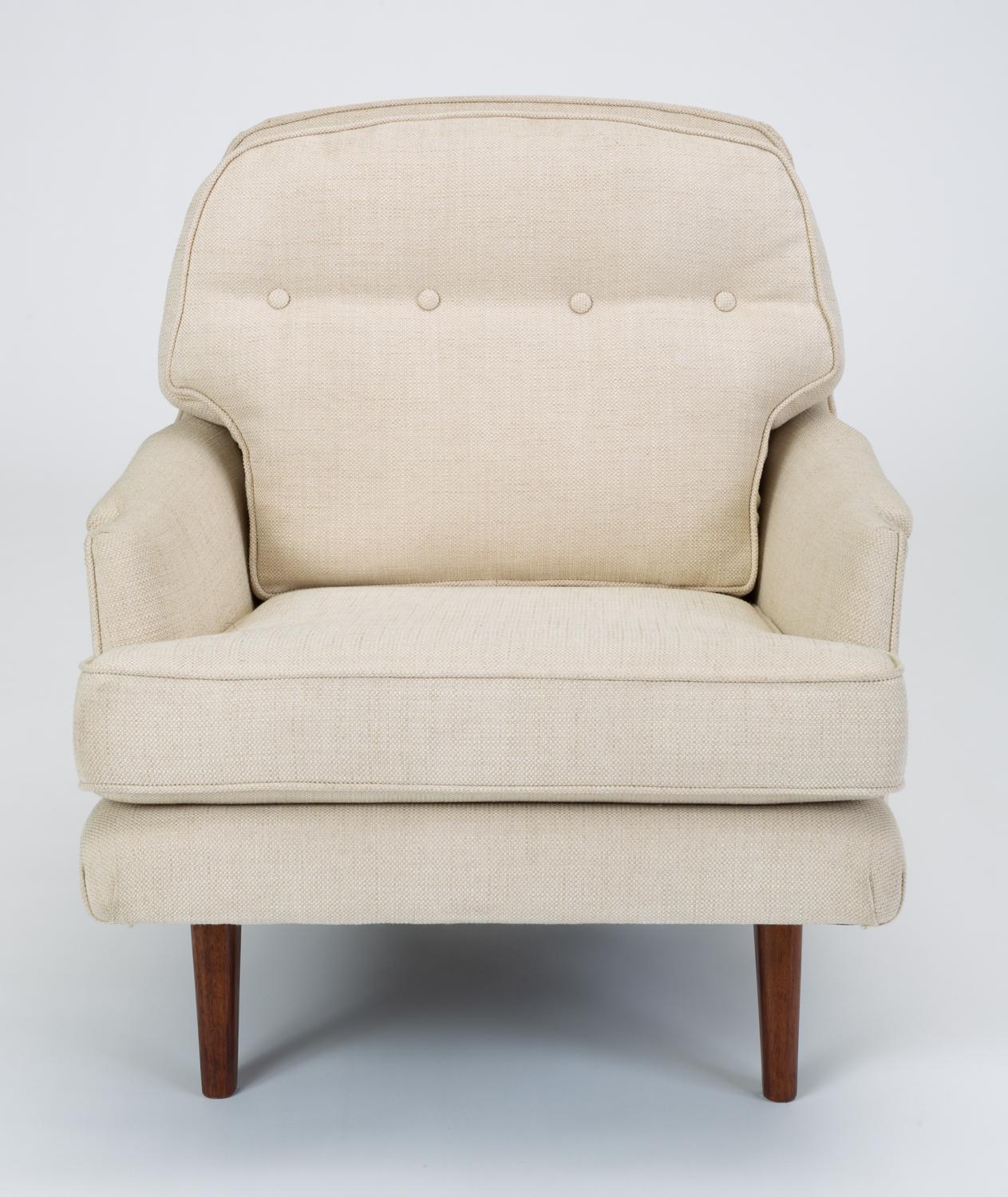 Designed by Edward Wormley’s successor at Dunbar, Roger Sprunger, the Model 484 lounge chair has a deep seat and notched armrests. The removable back and seat cushions are defined by welted seams and the back has a single row of tufting at shoulder