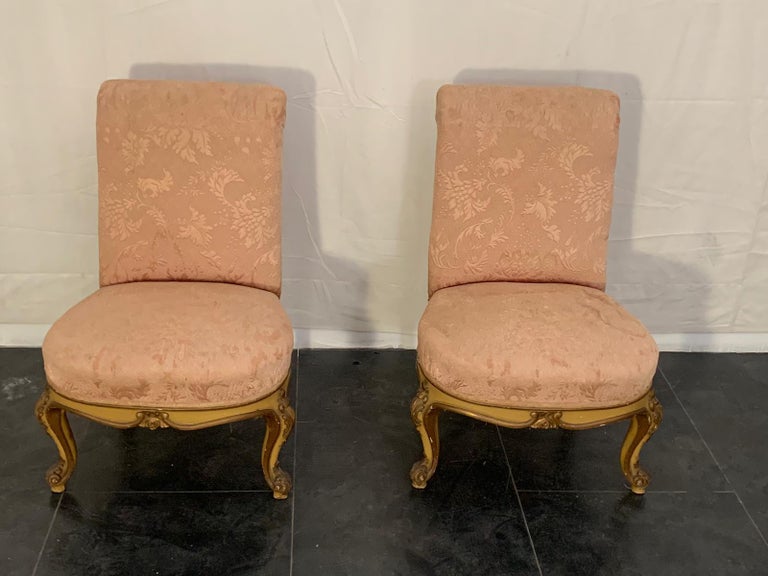 Pair of Louis XV style armchairs, produced in 1930, with finely painted legs painted in ocher yellow with gold edge, padded and covered in blush pink damask fabric.