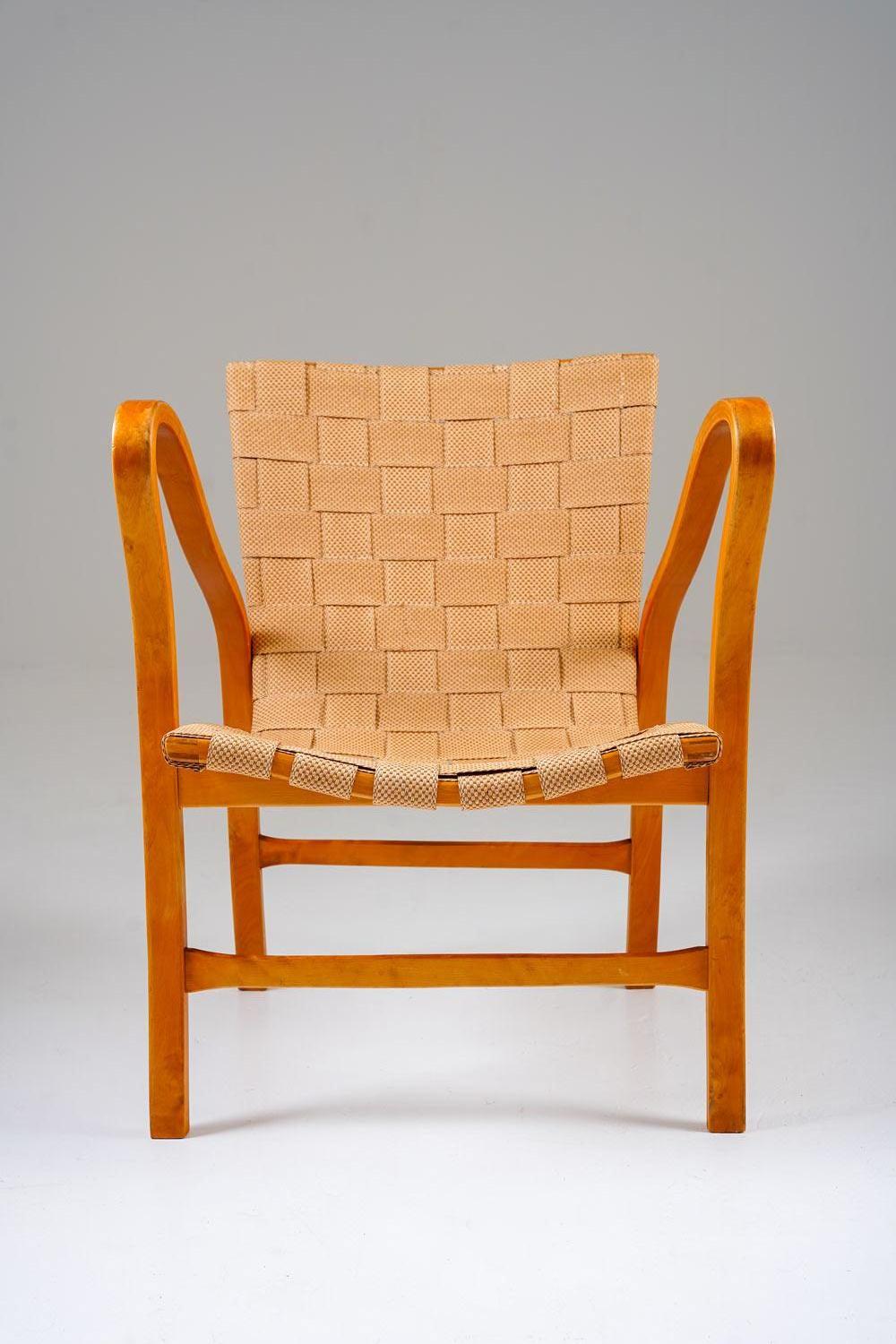 A rare pair of lounge chairs designed by Gustaf Axel Berg, model Tösen, produced in Sweden during the 1940s. Executed in bent beech with Berg’s signature sculptural armrests, the chairs feature original woven webbing seats and backs. The flowing