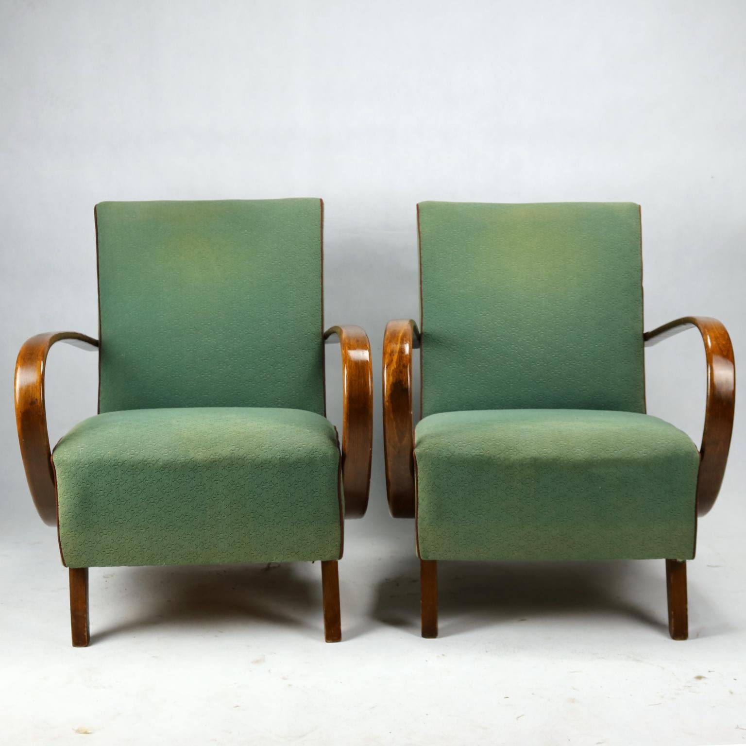 This lounge chairs, model No. 2, were designed by Jindrich Halabala and produced in  Czechoslovakia in the 1930s by UP Zavody Brno. The chairs features curved armrests and legs made from stained beech and are upholstered in original fabric. The