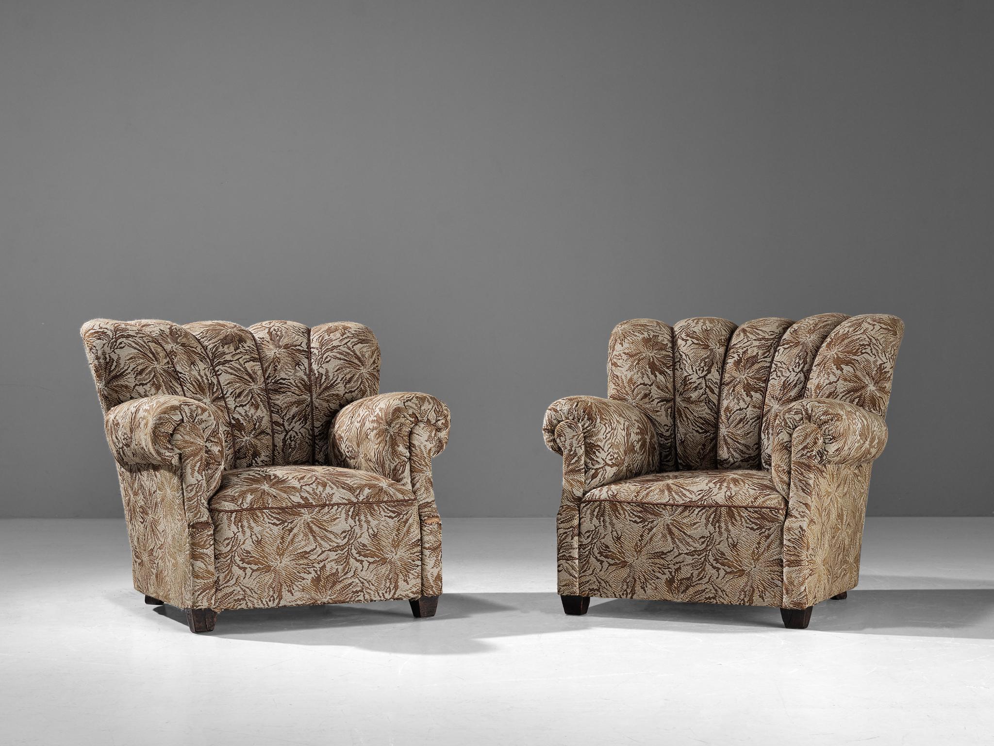 Club chairs, fabric, stained beech, Czech Republic, 1950s

These chairs are beautifully constructed featuring a shell shaped frame composed of diverging lines that brings a more open and inviting look to the quite solid design. The upholstery holds