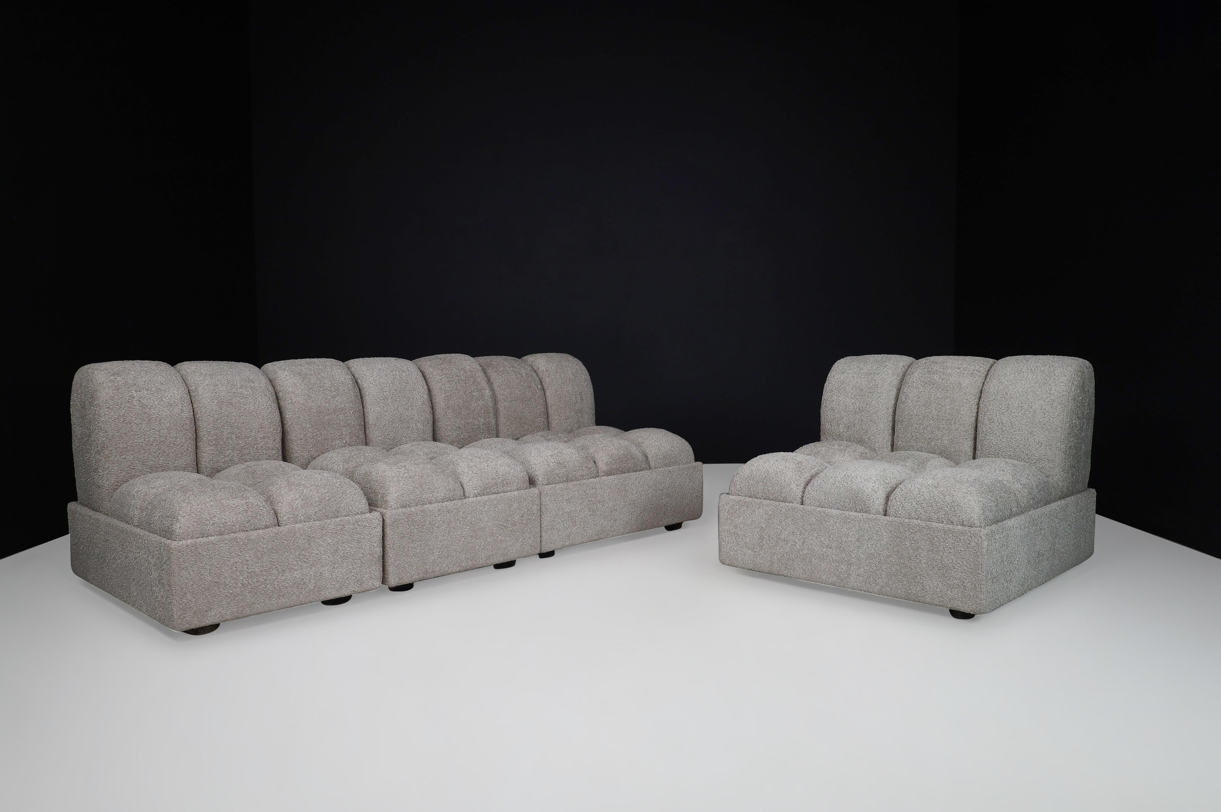 Lounge chairs or sectional sofa in re-upholstered fabric, Italy 1970s

Lounge chairs or sectional sofa were made and designed in Italy circa 1970. This design is characterized by re-upholstered bouclé tufted cushions that give these chairs a