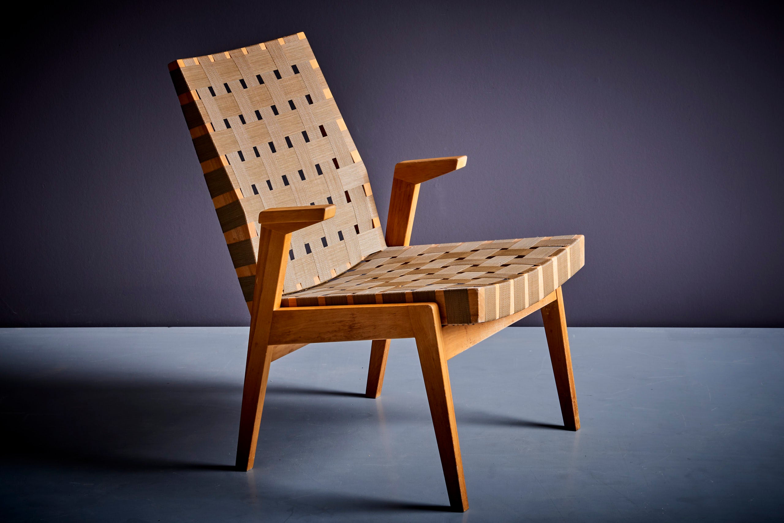 Lounge or arm chair in a webbing in dark beige with a light touch of khaki. By Arden Riddle.