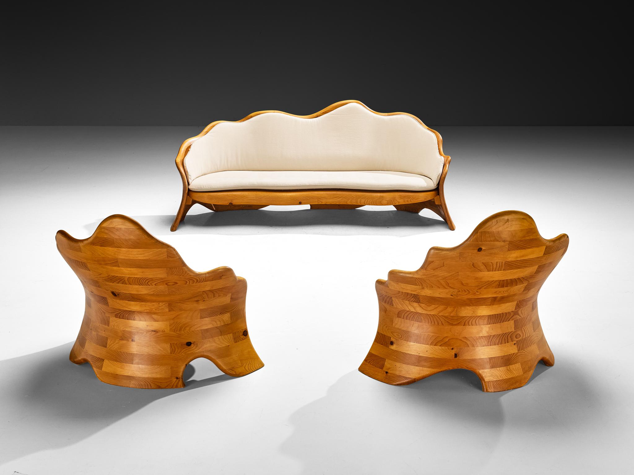 Living room set consisting of organic shaped sofa with matching lounge chairs in pine and reupholstered fabric from Europe, 1970s.

These sculptural sofa and lounge chairs, crafted in Europe during the 1970s, embody the organic spirit of its era
