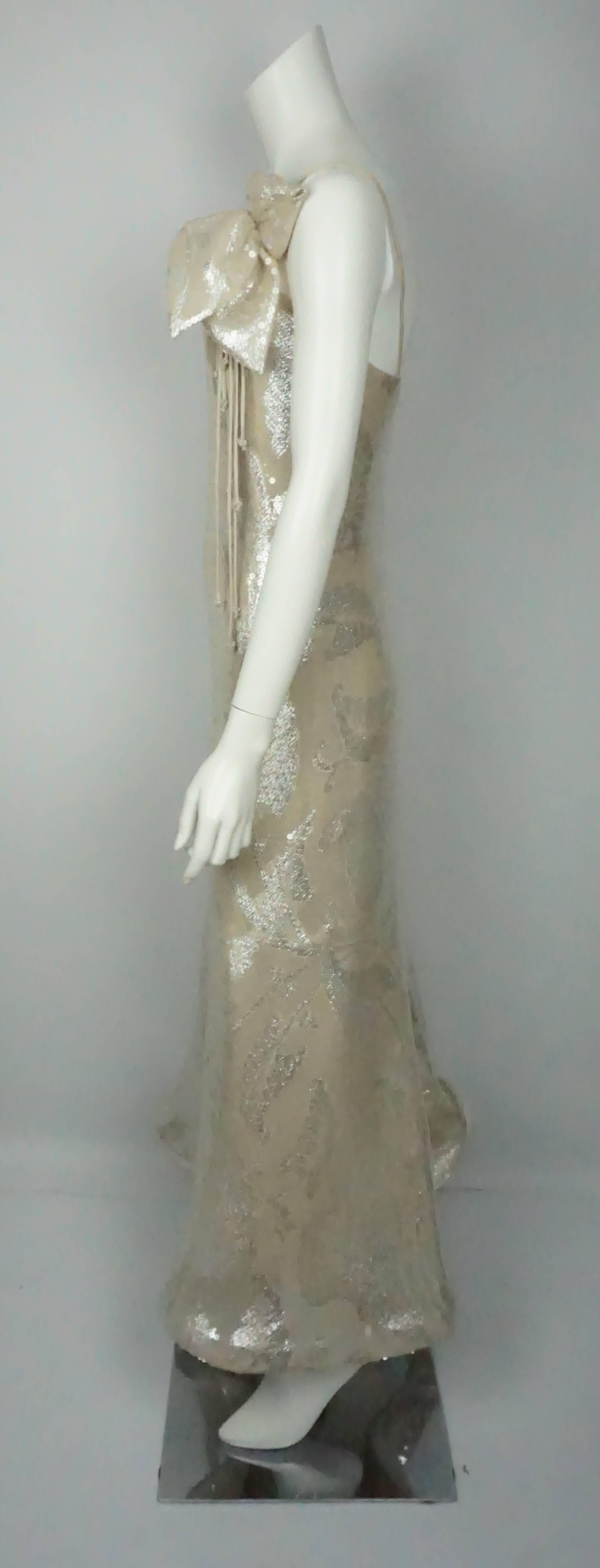 Lourdes Chavez Silver Sequin Gown - 4  This beautiful gown is in excellent condition. It has silk double spaghetti straps and a detachable bow like detail on the left shoulder with sequins and silk straps with beads on the ends coming out of it. The