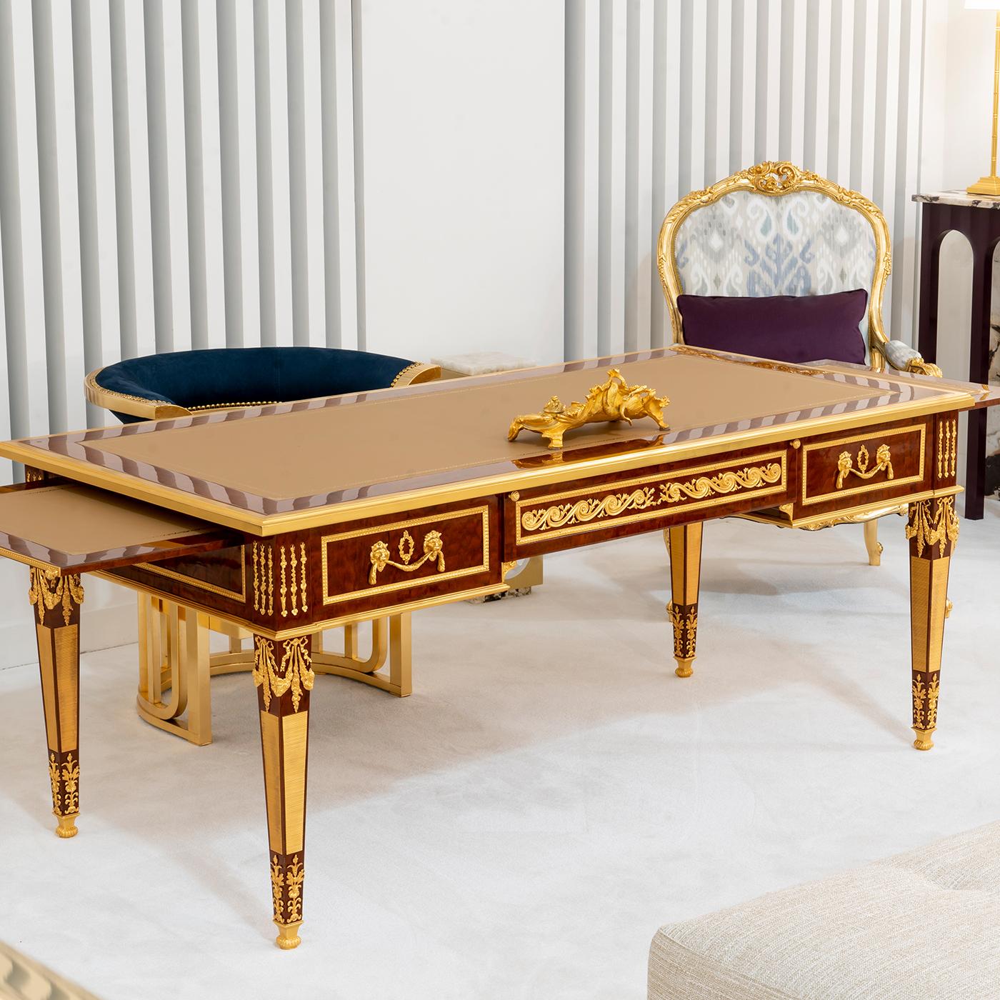 An exclusive Louis XVI-style design of extraordinary refinement, this writing desk will imbue a luxurious allure in a sophisticated interior. Handcrafted of Pomele Mahogany, it is enriched with bronze decorations plated with 24K gold. The top is