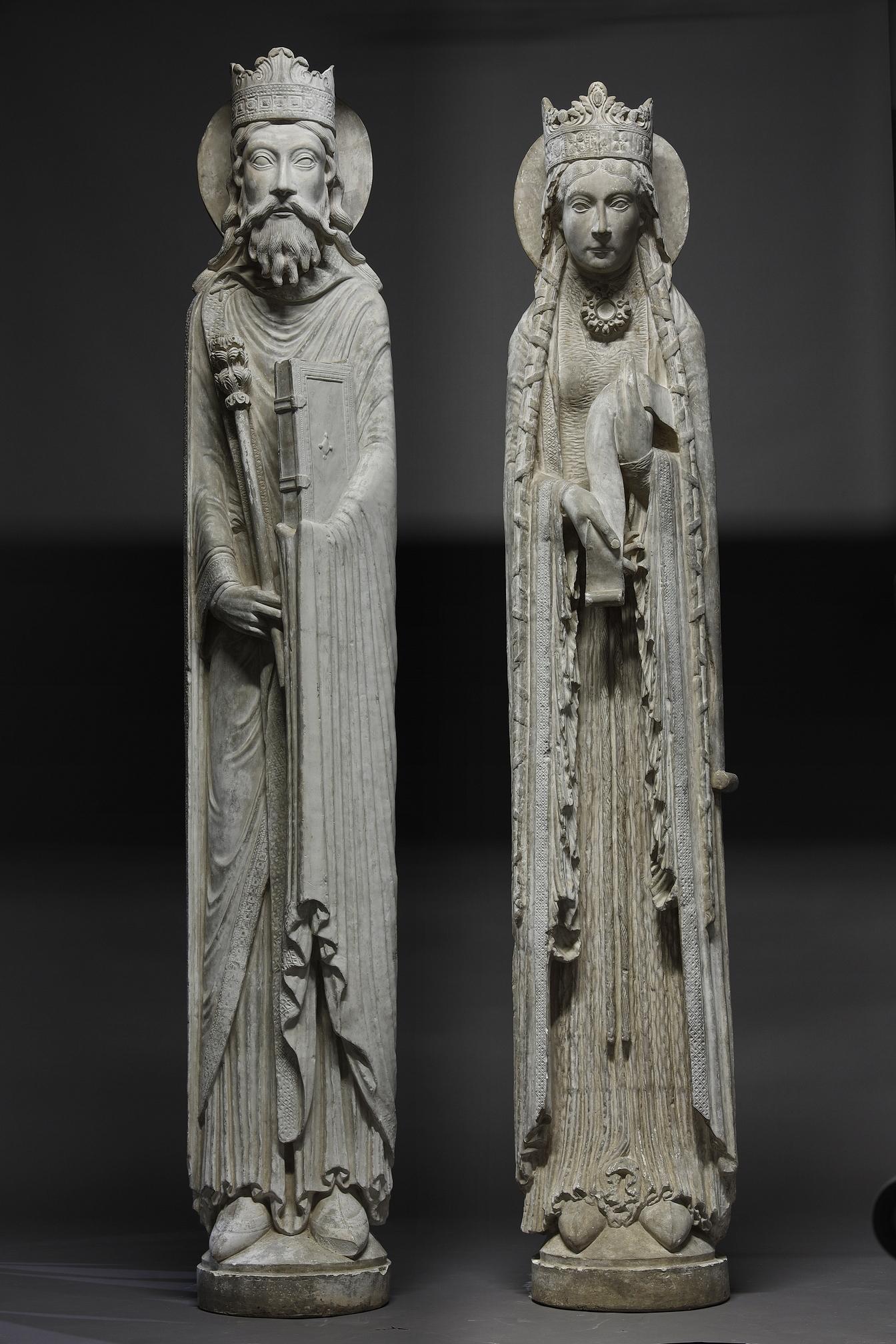 The limestone originals, circa 1180 - 1190, come from the western portal of Notre dame de Corbeil and are now housed in the Louvre Museum, after having spent many years in the abbey church of Saint-Denis. They are columnar statues, belonging to both
