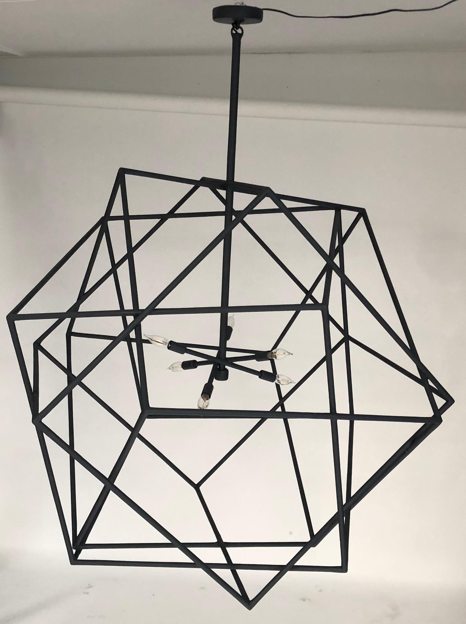 This geometric cubic chandelier is a blend of three cubes which are intertwined.
The black patina plaster of Paris gives an organic fell to this creation. The chandelier has six candelabra based sockets.

The finish can be done in custom colors