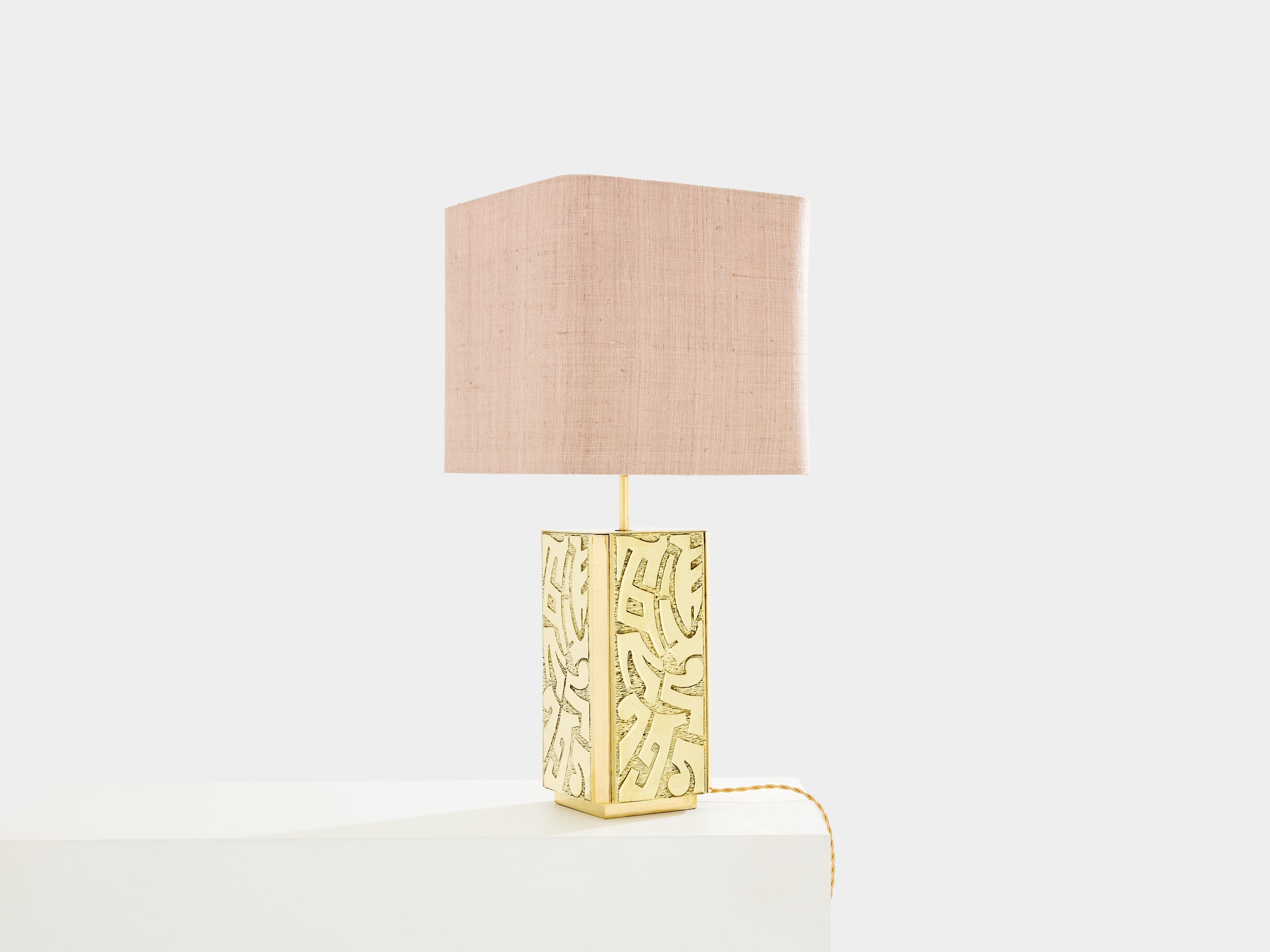 This unique table lamp, signed by Lova Creation, was designed and produced in the late 1970s. The sculptural quality of the piece is visually arresting, brass shaped delicately into abstract forms all along the base. Silky texture of the foreground