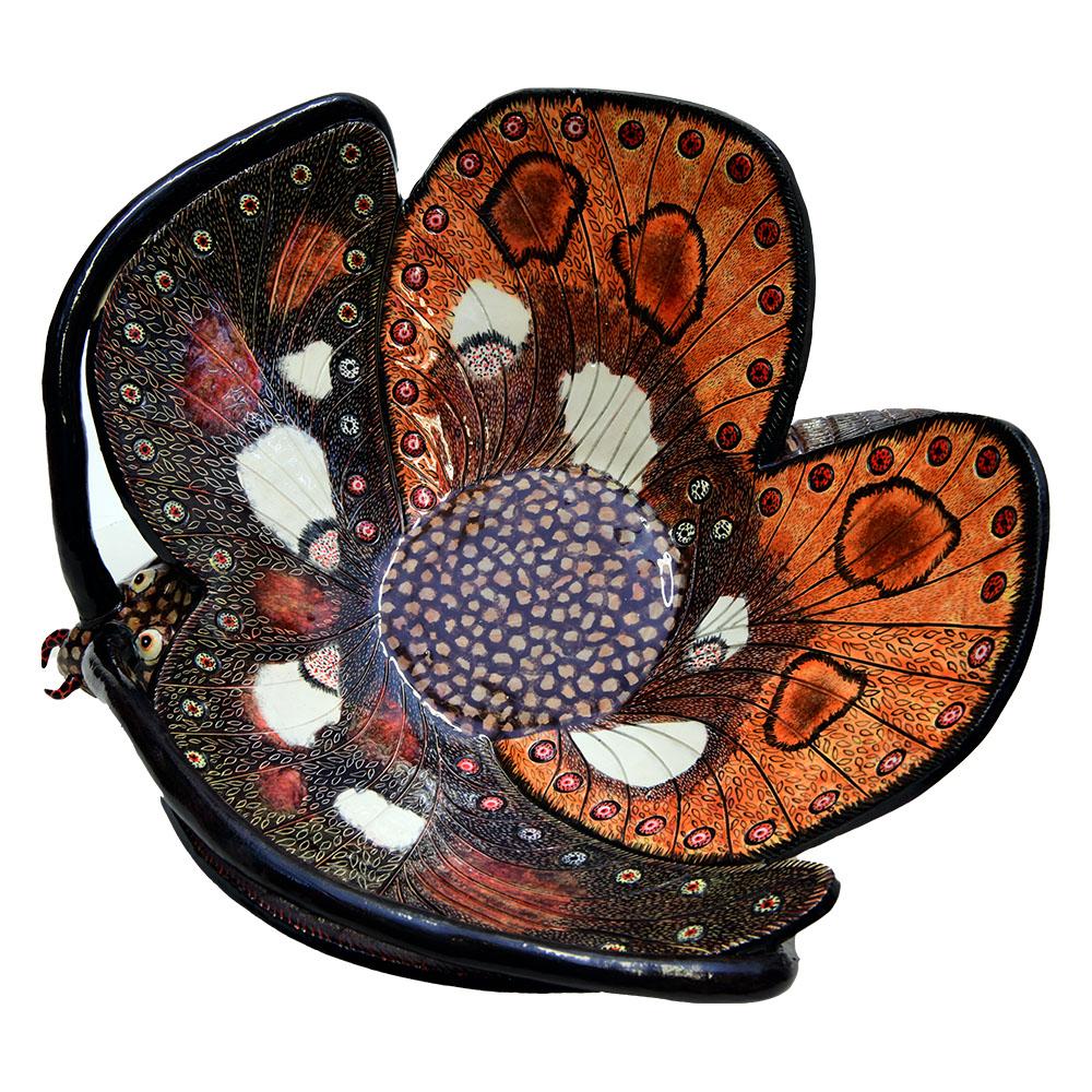 The Butterfly Bowl by Love Art Ceramics embodies the beauty of African flora and fauna. Hand-sculpted by Sbusiso Ndaba and hand-painted by Minenhle Nene in South Africa, this ceramic masterpiece stands 5 inches high, 15 inches in length, and 15