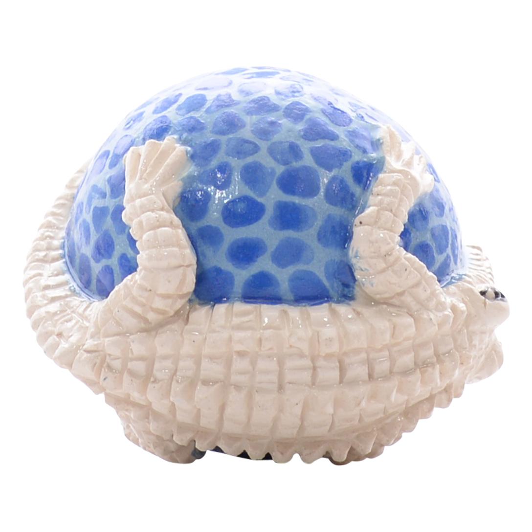 The ceramic Crocodile ornament by Love Art Ceramic is a homage to African culture. Hand-painted by Nozipho Ntshalintshali and hand-sculpted by Sondelani Ntshalintshali, this 2-inch high, 2-inch long, and 2-inch wide piece features relief-sculpted