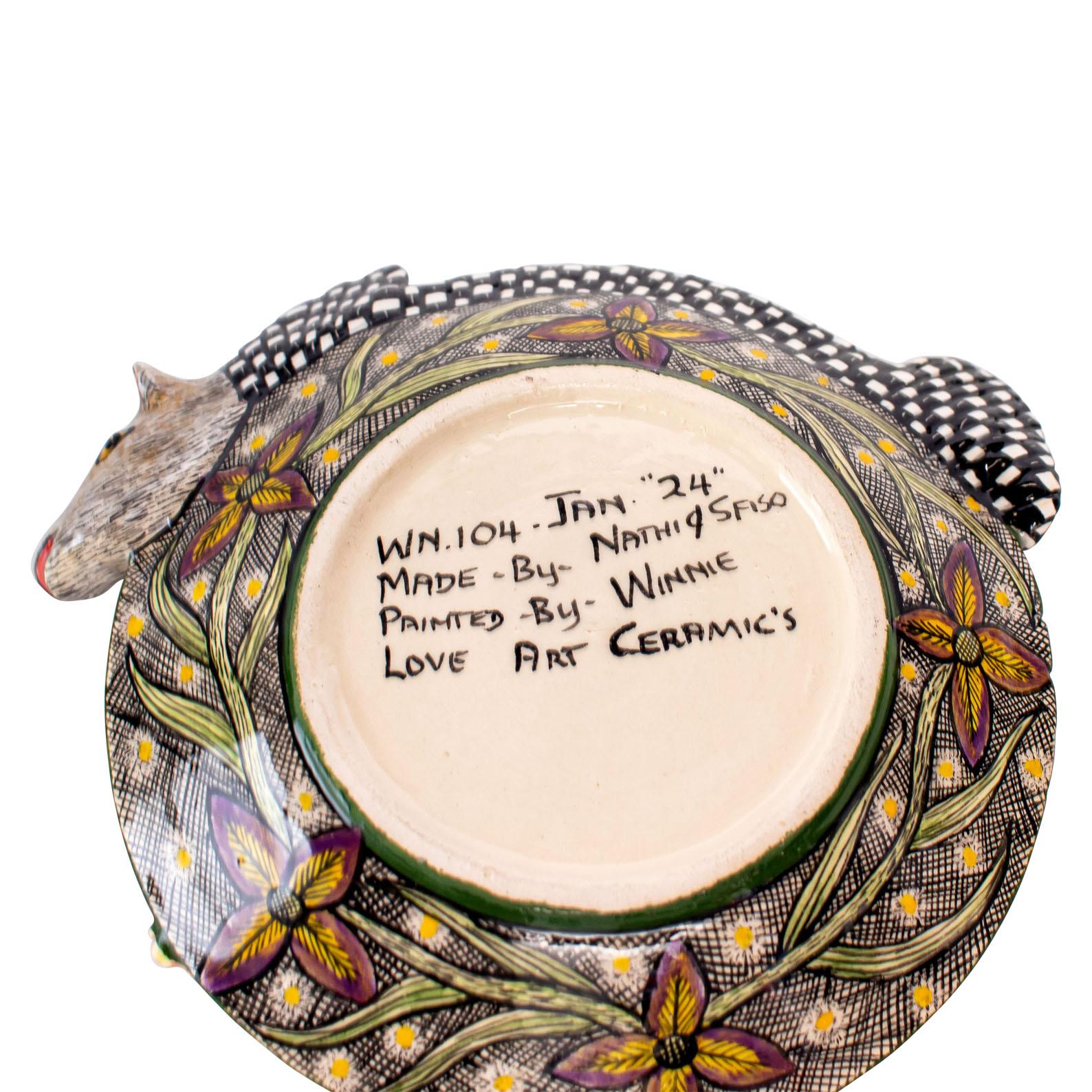 This handcrafted ceramic porcupine coin dish is a tribute to South African artistry and culture. Skillfully made and painted by local artisans, it features intricate details that celebrate the country's rich heritage. The porcupine shape adds a