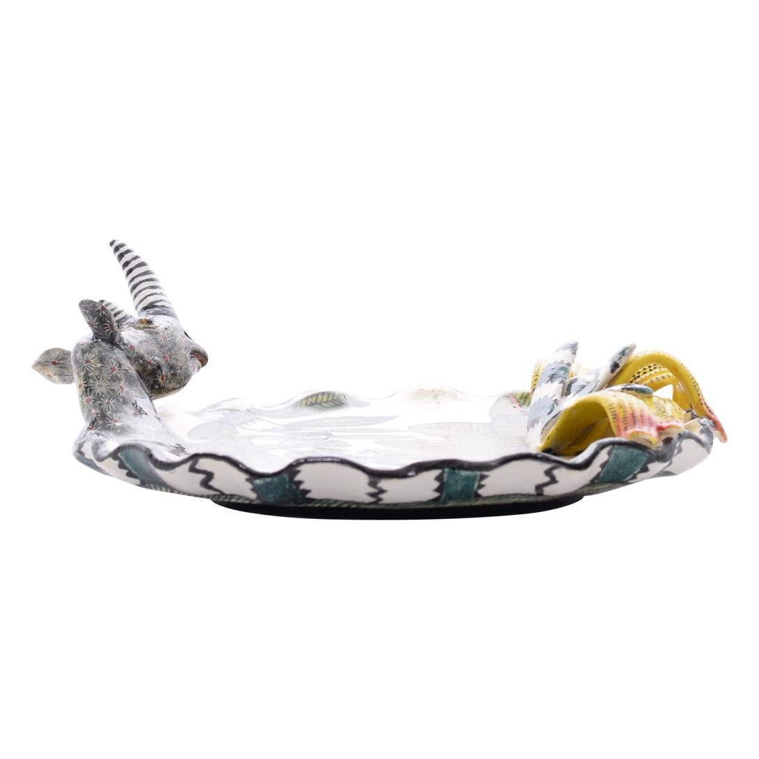 Crafted with precision and care by the skilled artisans of Love Art Ceramics in South Africa, this Rhino coin dish is a true testament to African artistry. Standing at 2 inches high, with dimensions of 6 inches in length and width, it is a compact