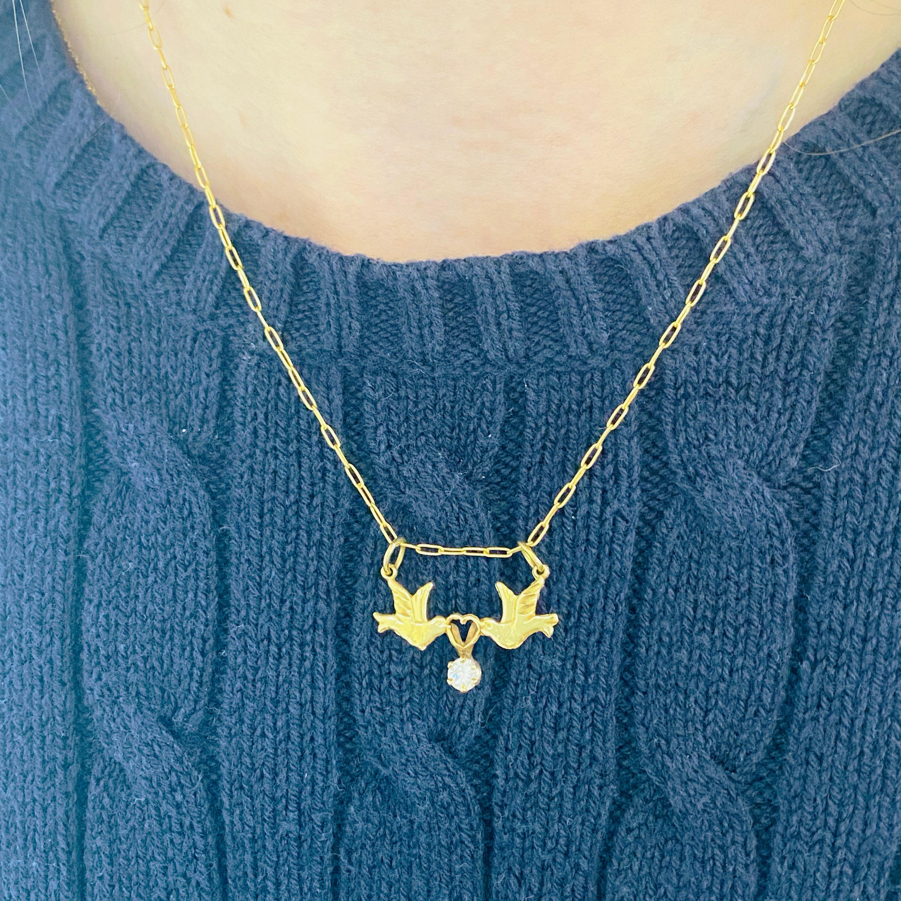 These gorgeous 14k yellow gold love birds gracing a 18k gold chain and delicately carrying a diamond dripping from an adorable heart is sure to put a smile on anyone's face! This necklace looks beautiful worn by itself and also looks wonderful in a