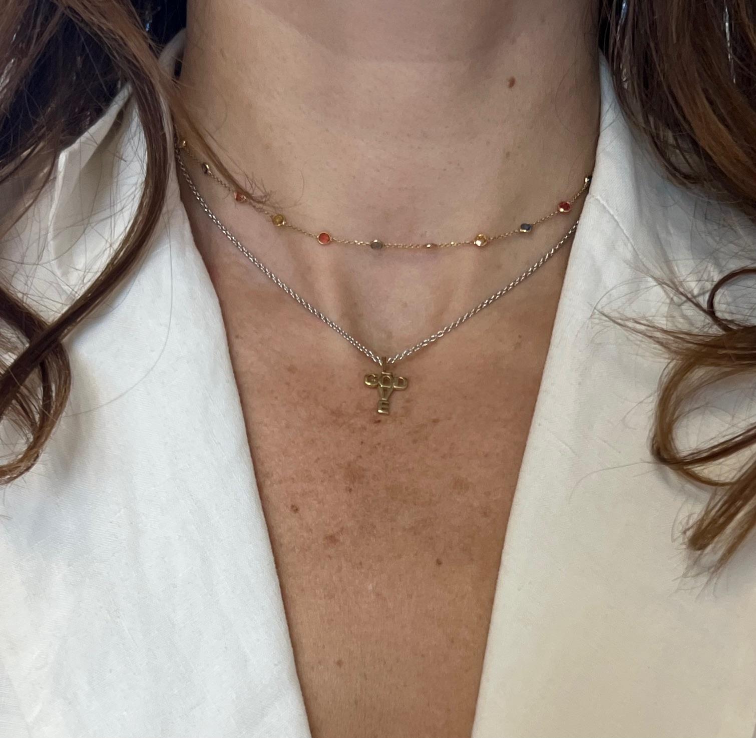This symbolic cross pendant is crafted in solid 18k yellow gold and designed entirely from letters. The word LOVE forms the vertical beam, while GOD runs horizontally, both meeting at the shared ‘O’ in the center. The result is a unique and