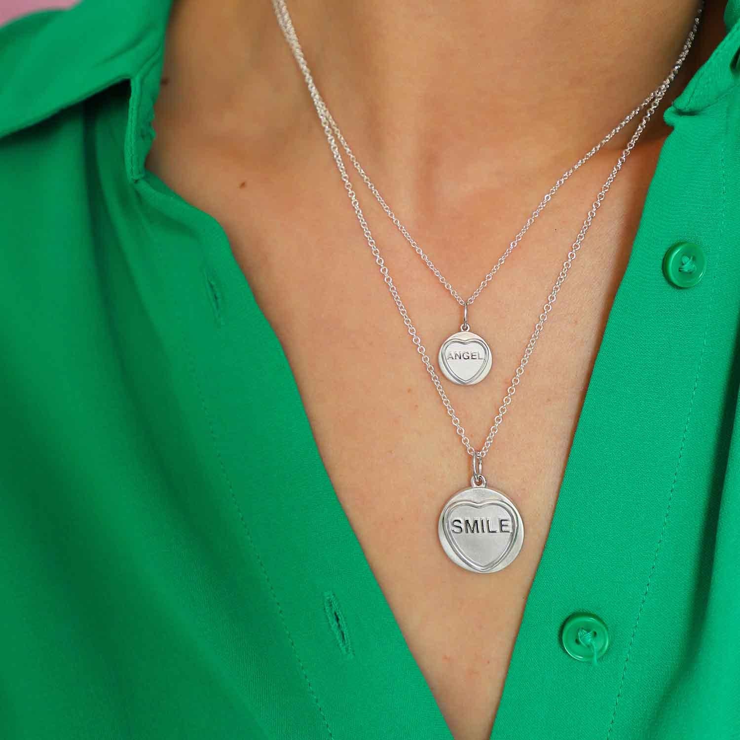 Add a touch of enchantment to your collection with our Angel Small Silver Love Heart Necklace. This exquisite piece, perfect as a heartfelt gift, is sure to delight. Inspired by the beloved British Love Hearts, the pendant captures nostalgic charm