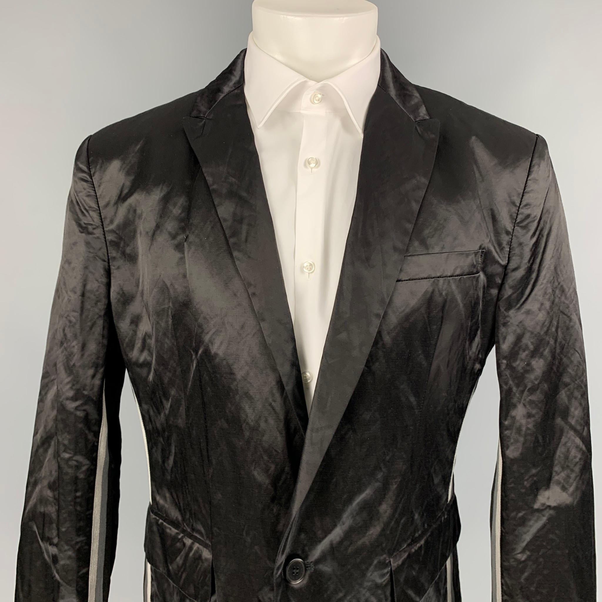 LOVE MOSCHINO sport coat comes in a black wrinkled cotton blend with a full liner featuring a peak lapel, flap pockets, stripe trim, and a single button closure.

Very Good Pre-Owned Condition.
Marked: D 54 / GB 44 / F 46 / US 38 / I