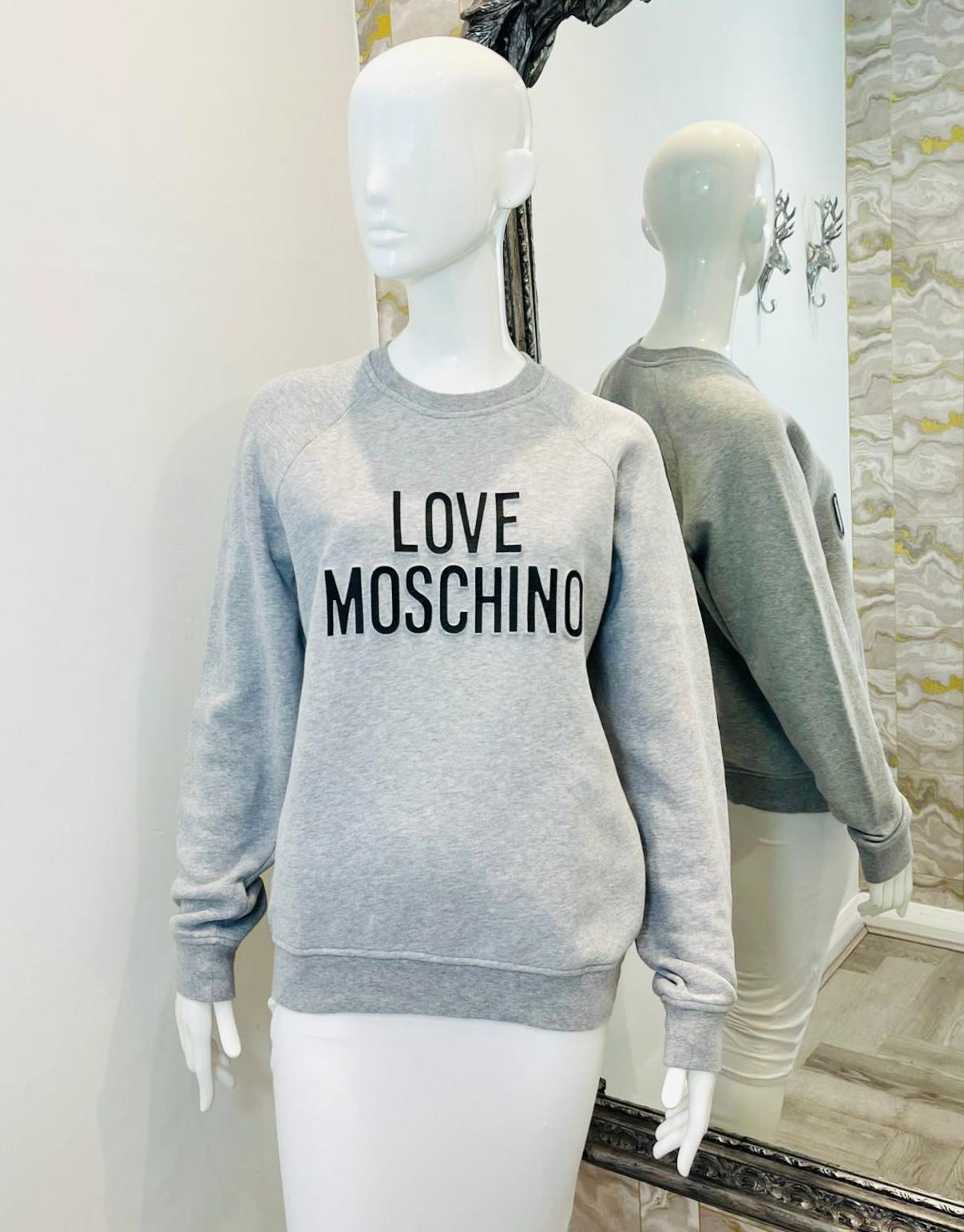 Love Moschino 'Logo' Cotton Sweatshirt

Light grey top designed with black 'Love Moschino' inscription to the front.

Featuring loose-fit silhouette, long sleeves and crew neckline.

Size – S

Condition – Very Good

Composition – 100% Cotton