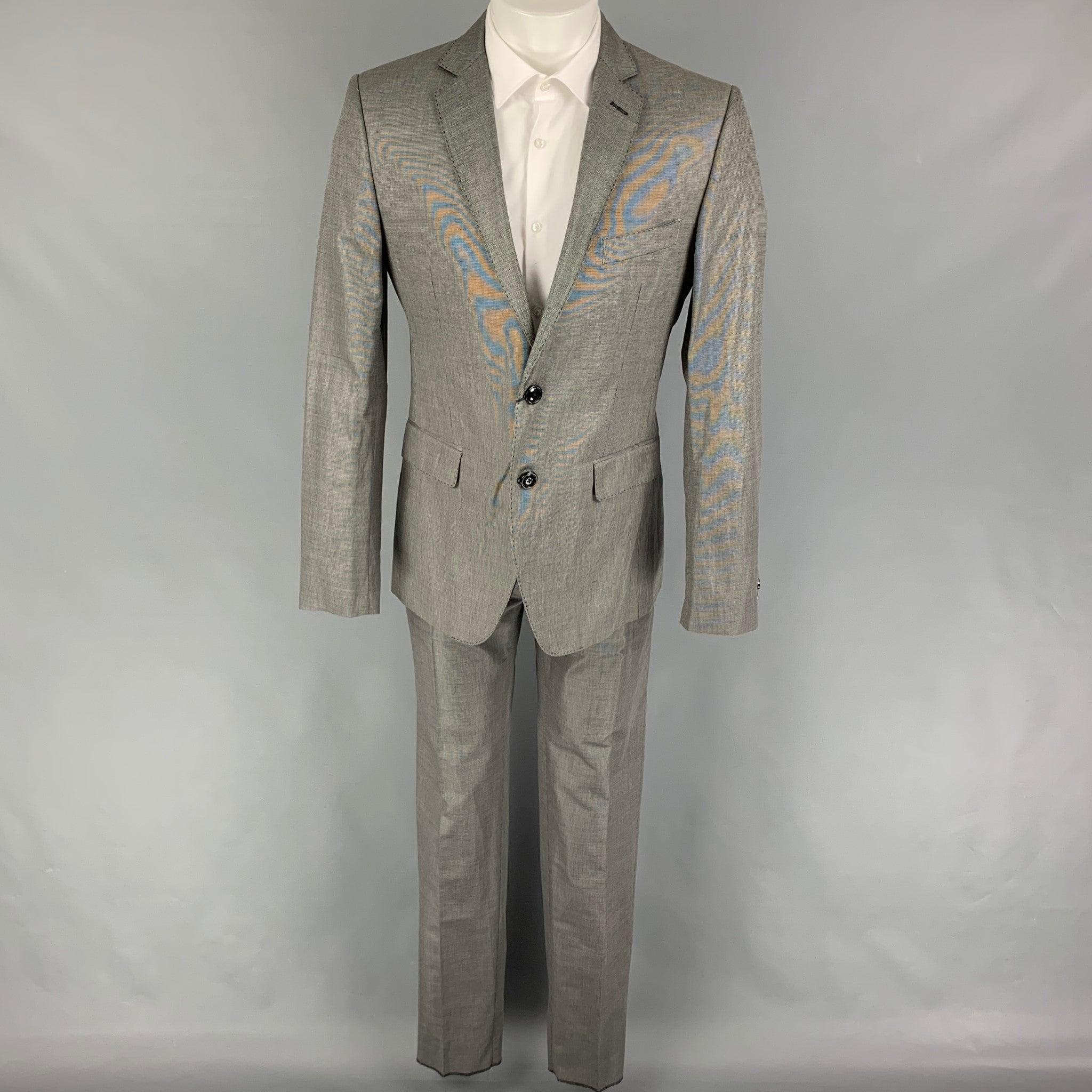 LOVE MOSCHINO
suit comes in a black & grey nailhead cotton blend with a full liner and includes a single breasted, double button sport coat with a lapel and matching flat front trousers. Made in Romania. New with tags. 

Marked:   D 50 / GB 40 / F