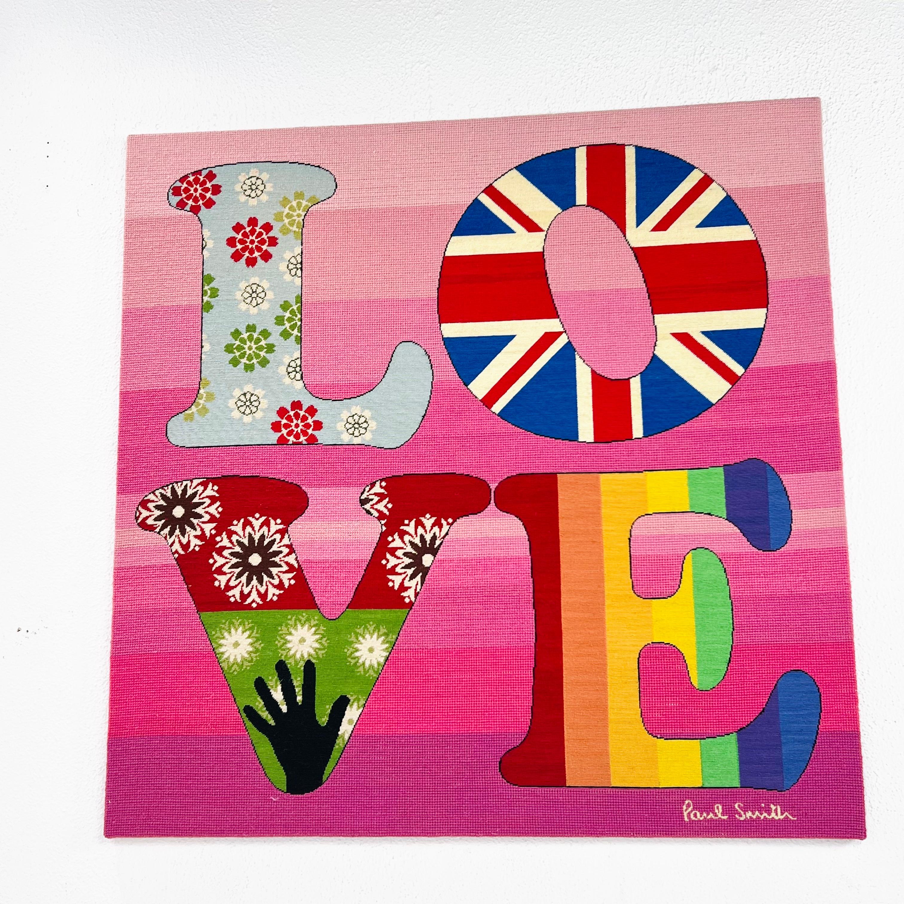 Pink/multicolor wool needlepoint 'LOVE' wall art by Paul Smith for The Rug Company. In its Sixties Summer of Love theme, the design captures Smith's distinctively British identity and love of vibrant color, while subtly incorporating his hallmark