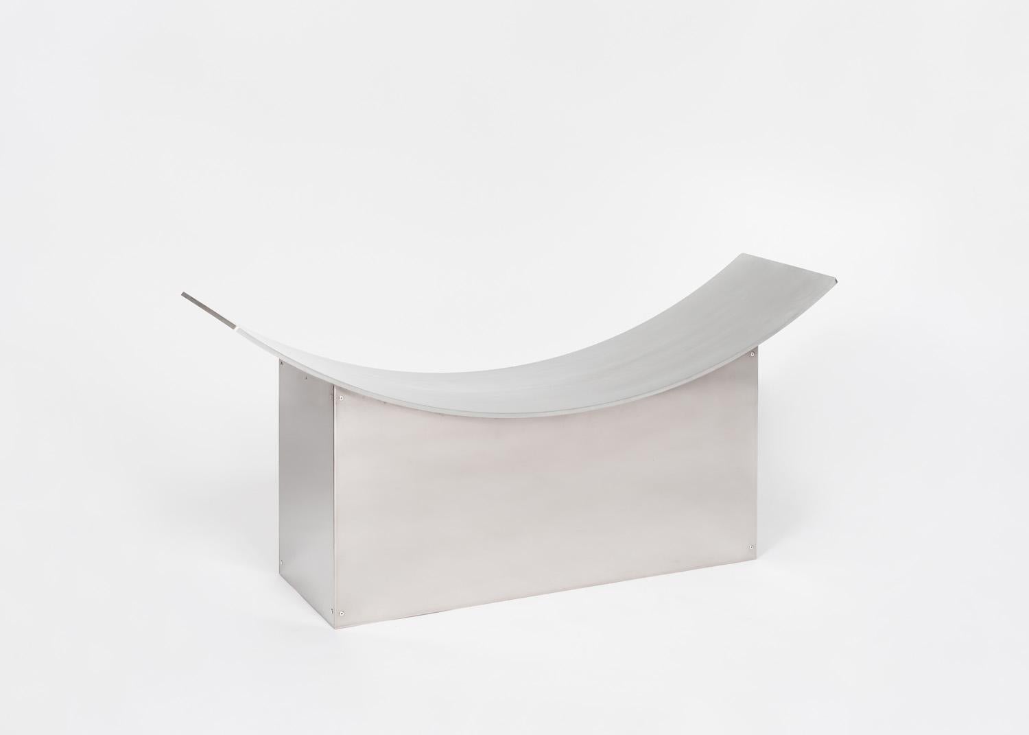 The Love Seat by ELIAS VAN ORSHAEGEN is an idea that came alive during the lockdown. A bench which makes us sit closer to each other. A curved aluminium plate of one meter fifty, symbolising the social distance, poetically brings the users closer