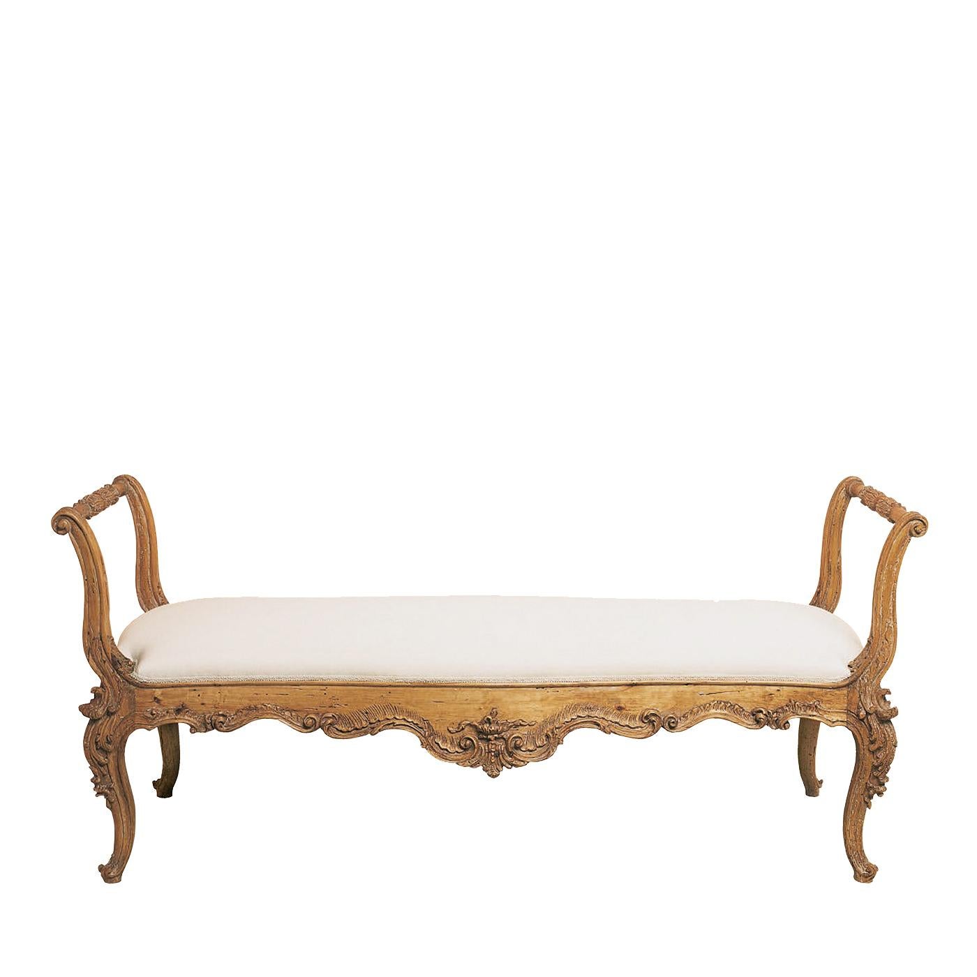 This charming love seat was crafted in solid wood that was carved by hand and given a natural finish that enhances the sophistication of the classically inspired curls on the wood. The elongated structure is accented with two armrests on the sides