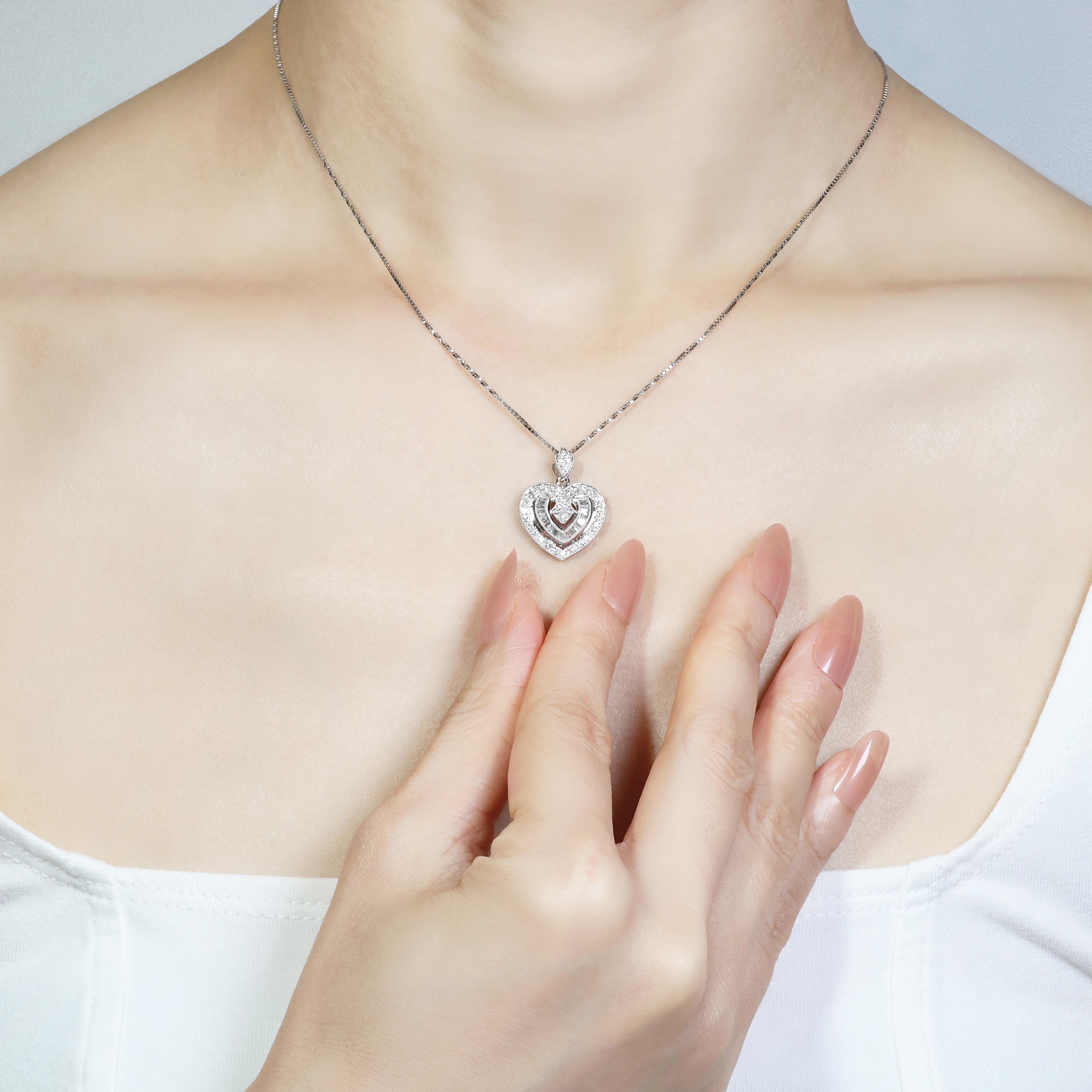 This exquisite 18K white gold heart pendant features 33 round brilliant diamonds, with a total carat weight of 0.33ct, boasting a G colour grade and VS clarity grade for exceptional brilliance. Complementing these are 19 taper-shaped diamonds with a