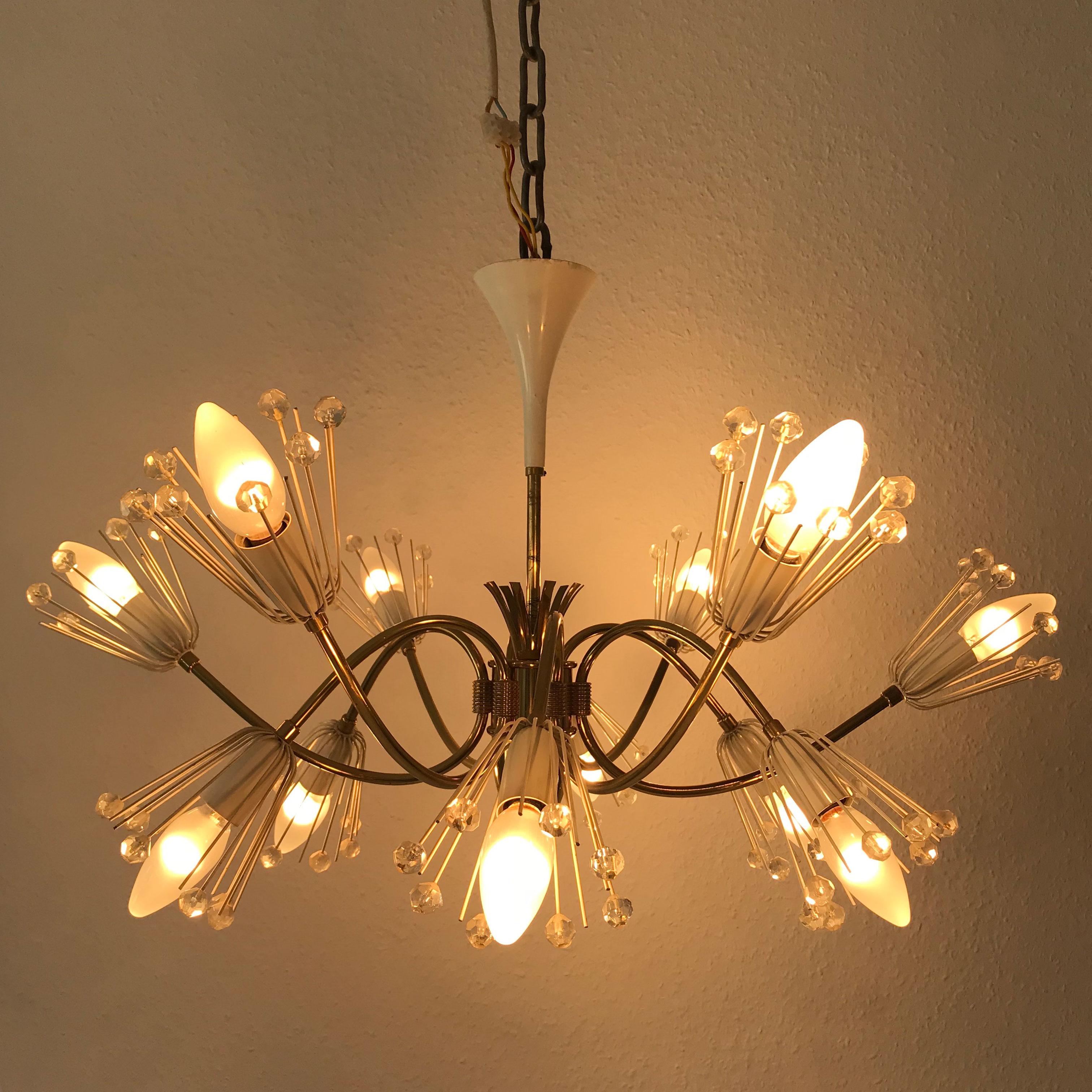 Gorgeous Mid-Century Modern 12-armed chandelier. Designed by Emil Stejnar for Rupert Nikoll, Vienna, Austria, 1950s. 

Executed in brass, Lucite pearls and white lacquered metal. The chandelier needs 12 x E14 Edison screw fit bulbs. It is wired, in