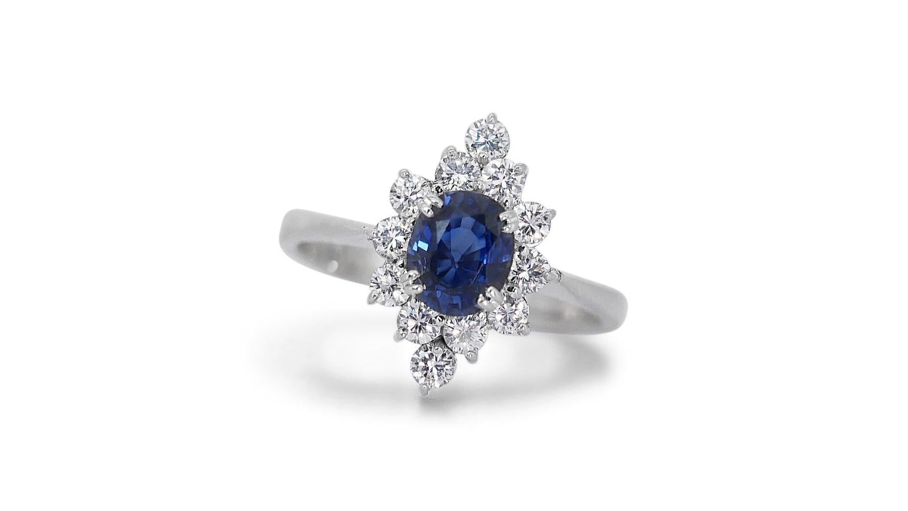 This stunning 1.37 carat oval natural sapphire ring in 18K white gold is the perfect way to show your loved one how much you care. The 0.89 carat oval natural sapphire is the centerpiece of the ring, and its dazzling brilliance is sure to turn