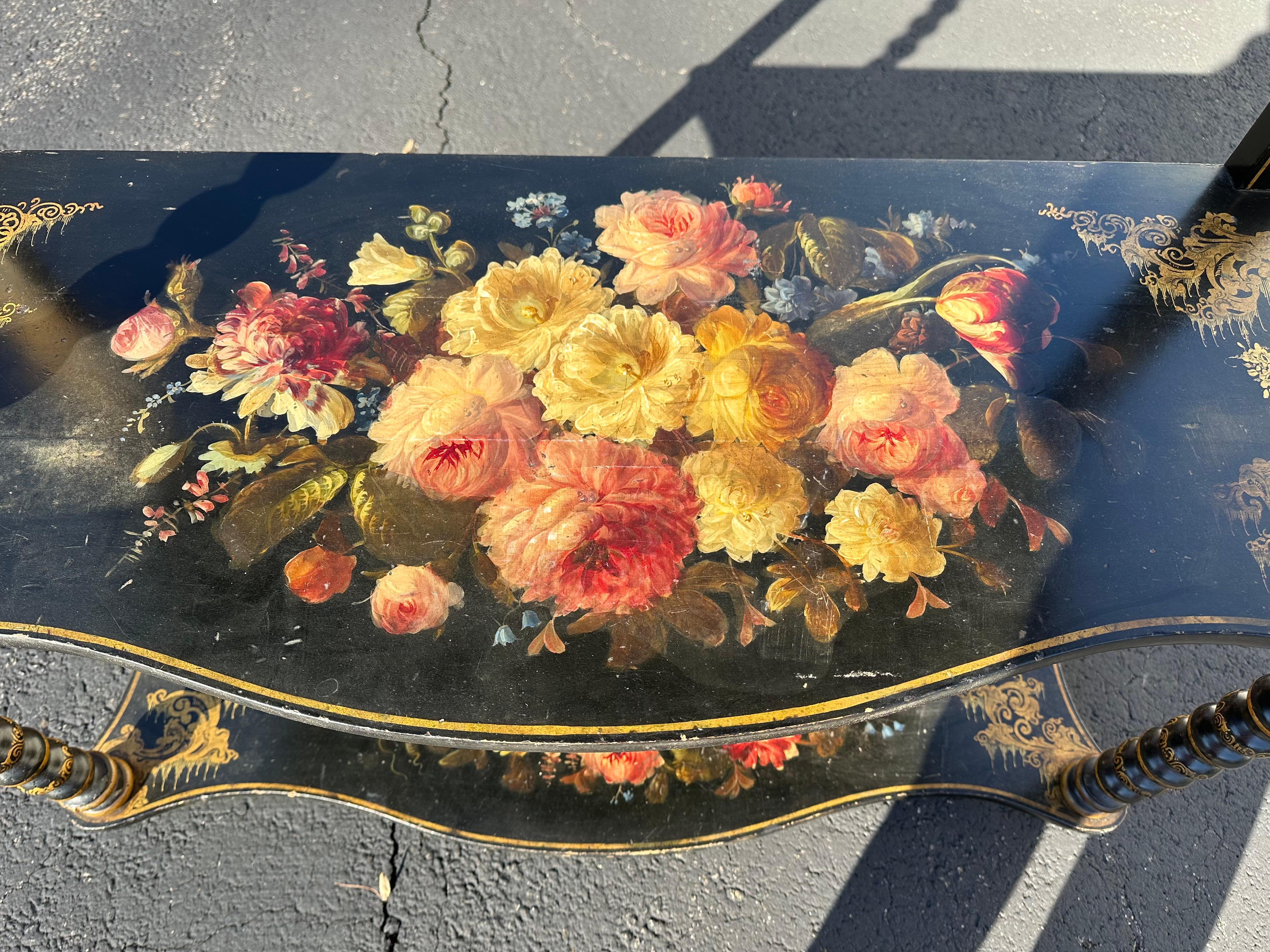 Very pretty 3 tier console having black background and meticulously detailed handpainted floral decoration.  Candlestick turned front pieces add to the beauty.