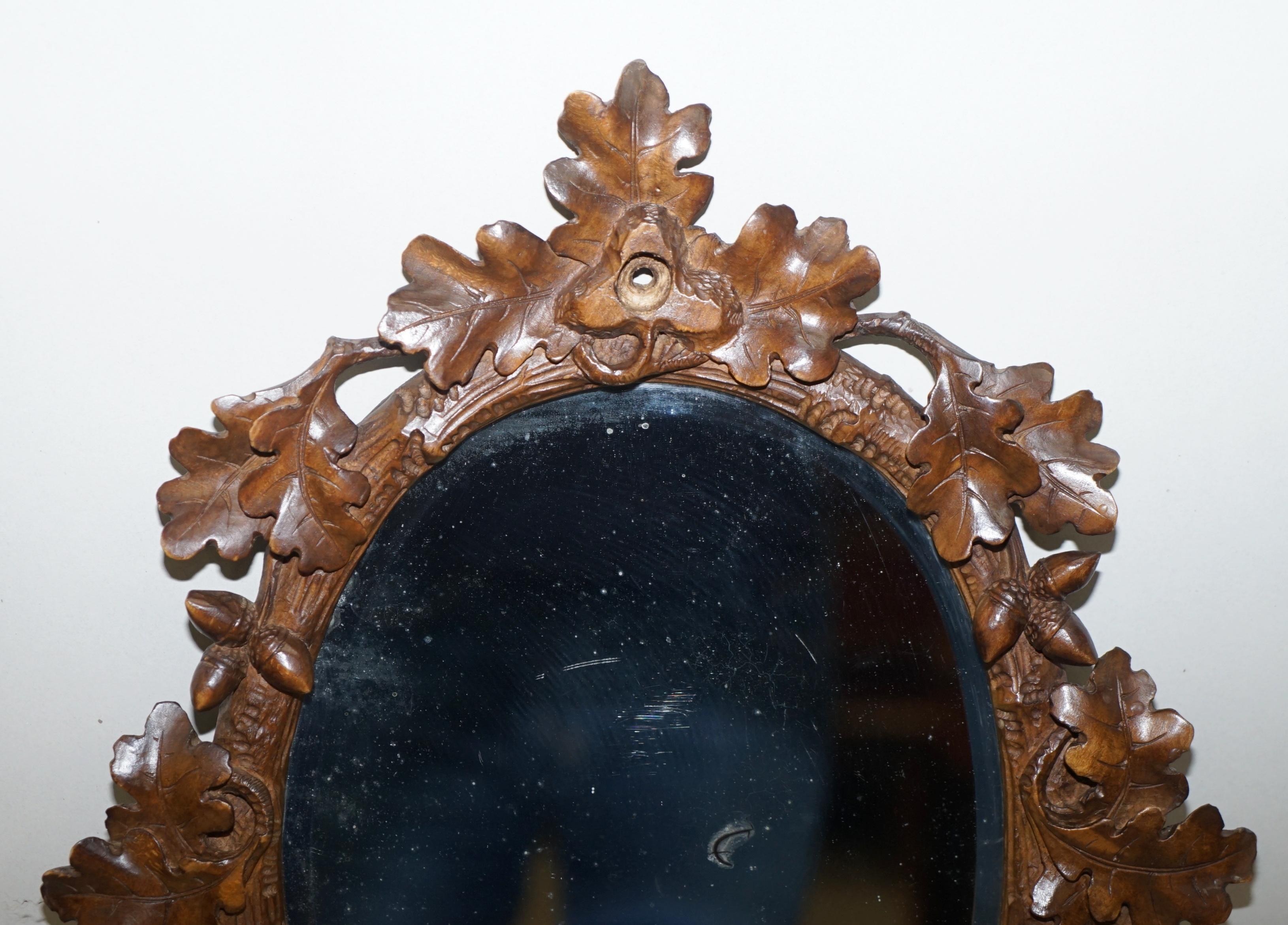 We are delighted to offer for sale this stunning hand carved Black Forest wood wall mirror

A very good looking and decorative vanity mirror, the plate is original circa 1900 and lightly distressed with some pitting, there is a hole in the top of